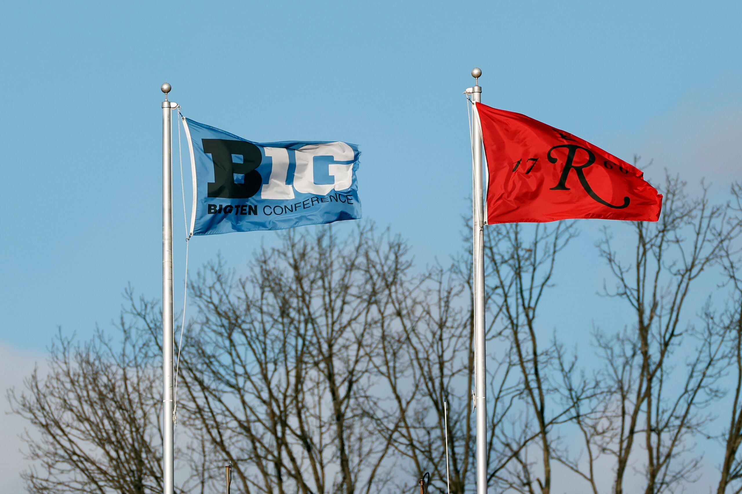 A Big Ten Conference and Rutgers flag seen flying during the second half of an NCAA college football game between Penn State and Rutgers on Saturday, Dec. 5, 2020, in Piscataway, N.J. Penn St. won 23-7. (AP Photo/Adam Hunger)