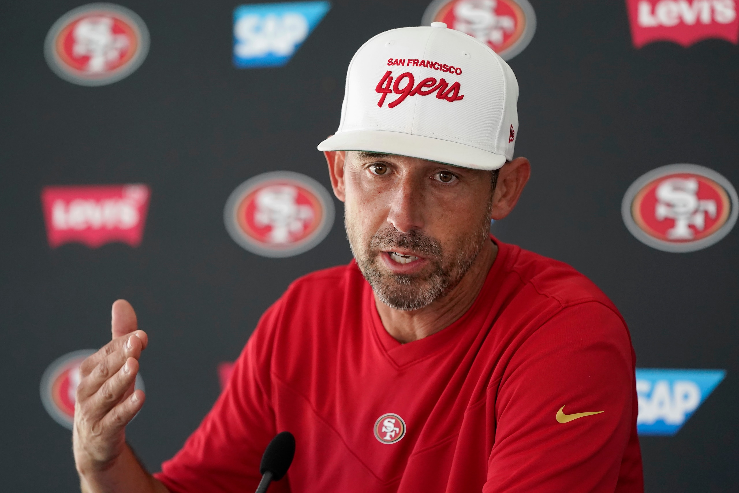 San Francisco 49ers head coach Kyle Shanahan speaks at a news conference at NFL football training camp in Santa Clara, Calif., Tuesday, Aug. 10, 2021. (AP Photo/Jeff Chiu)