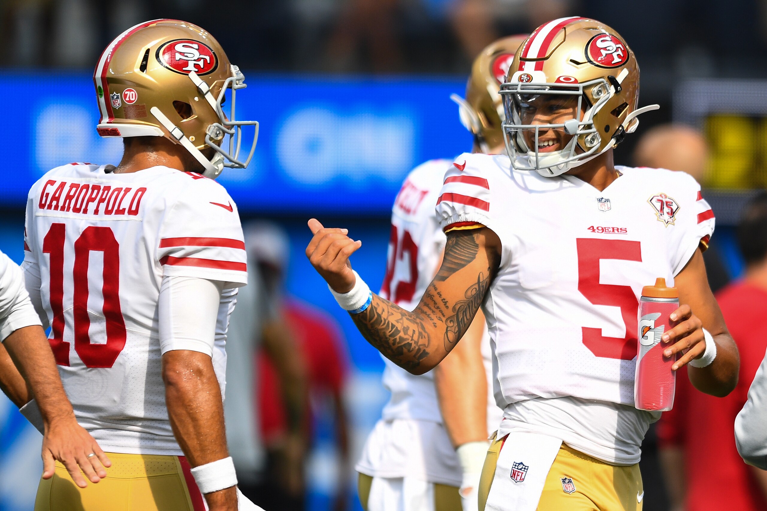 INGLEWOOD, CA - AUGUST 22: San Francisco 49ers quarterback Jimmy Garoppolo (10) and quarterback Trey Lance (5) look on before the NFL preseason game between the San Francisco 49ers and the Los Angeles Chargers on August 22, 2021, at SoFi Stadium in Inglewood, CA. (Photo by Brian Rothmuller/Icon Sportswire via Getty Images)