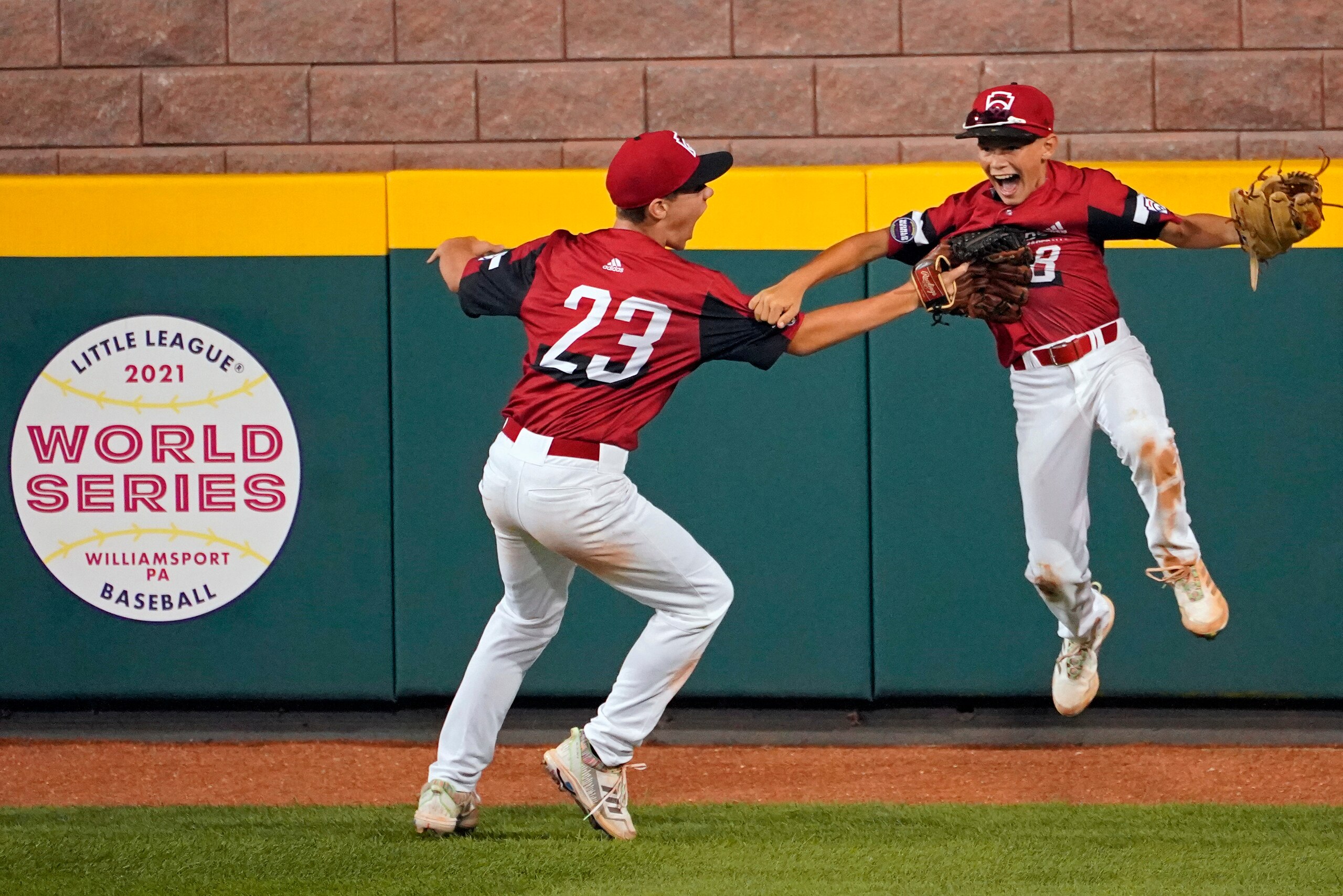 Hamilton, Ohio centerfielder Krew Brown (8) and right fielder JJ Vogel (23) celebrate the win over Torrance, Calif. a baseball game at the Little League World Series tournament in South Williamsport, Pa., Thursday, Aug. 26, 2021. Ohio won the game 4-2. (AP Photo/Tom E. Puskar)
