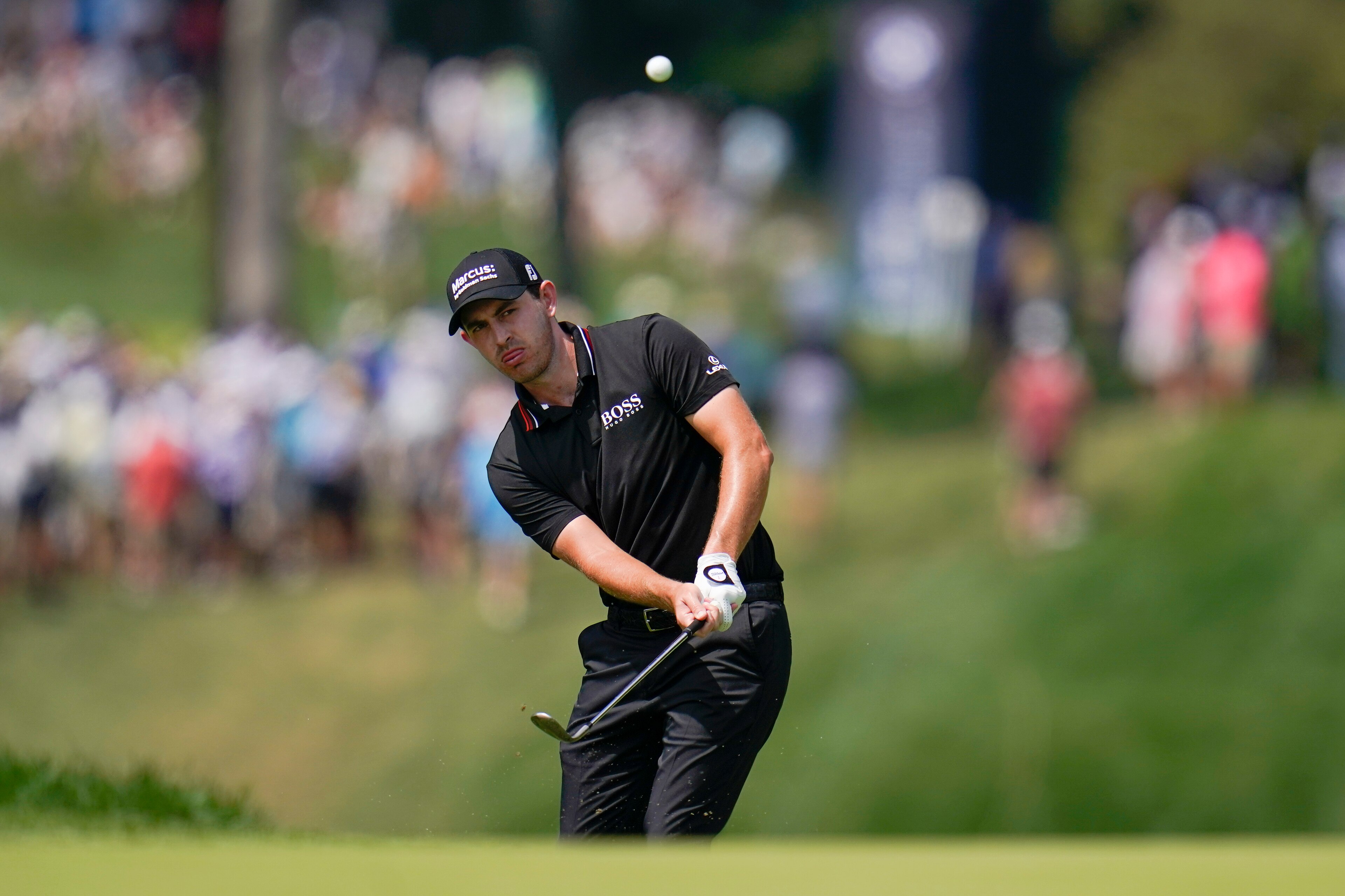 Patrick Cantlay chips onto the fourth green during the third round of the BMW Championship golf tournament, Saturday, Aug. 28, 2021, at Caves Valley Golf Club in Owings Mills, Md. (AP Photo/Julio Cortez)