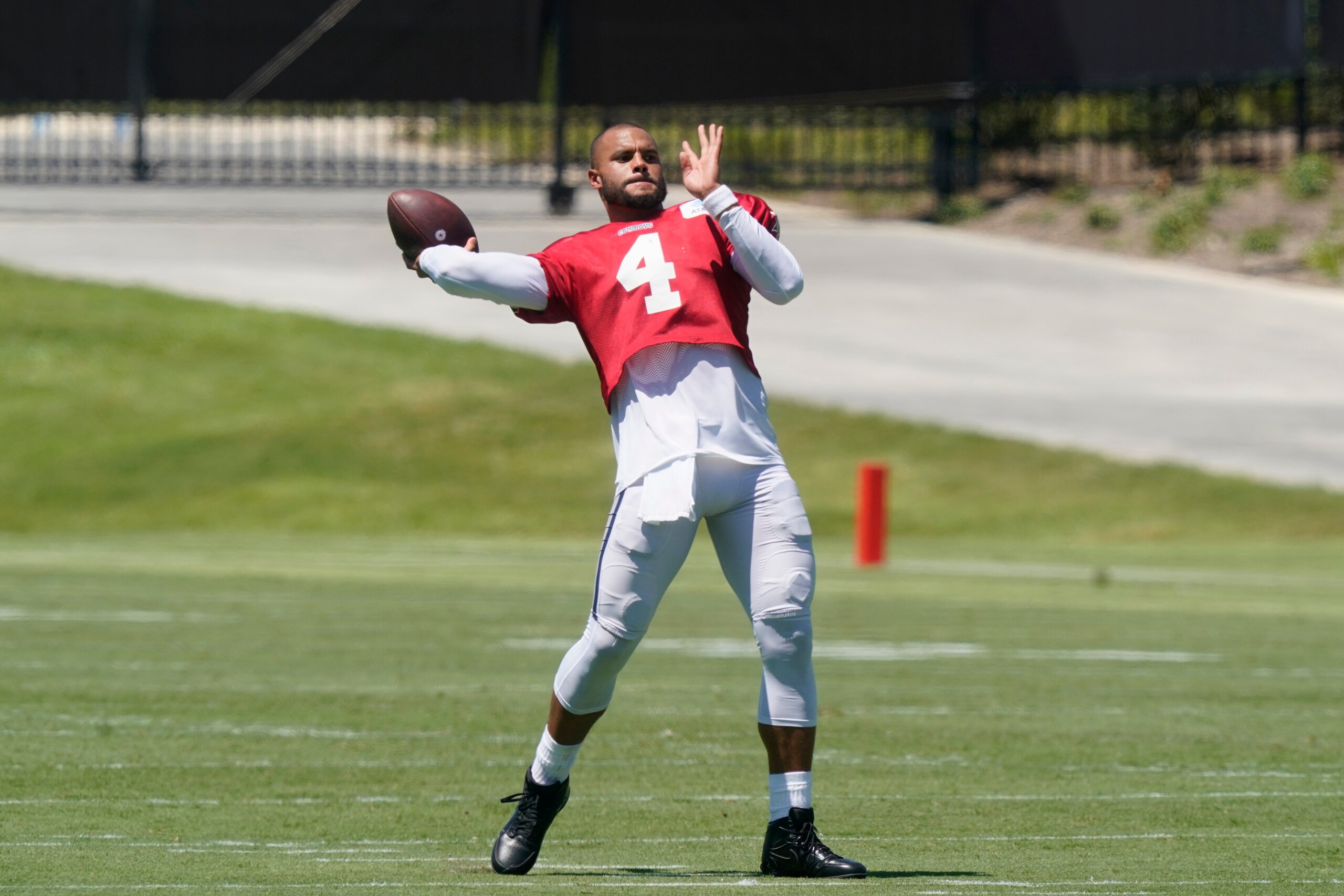 Dallas Cowboys quarterback Dak Prescott (4) tosses a pass during NFL football practice in Frisco, Texas, Tuesday, Aug. 24, 2021. (AP Photo/LM Otero) Dallas Cowboys quarterback Dak Prescott (4) tosses a pass during NFL football practice in Frisco, Texas, Tuesday, Aug. 24, 2021. (AP Photo/LM Otero)