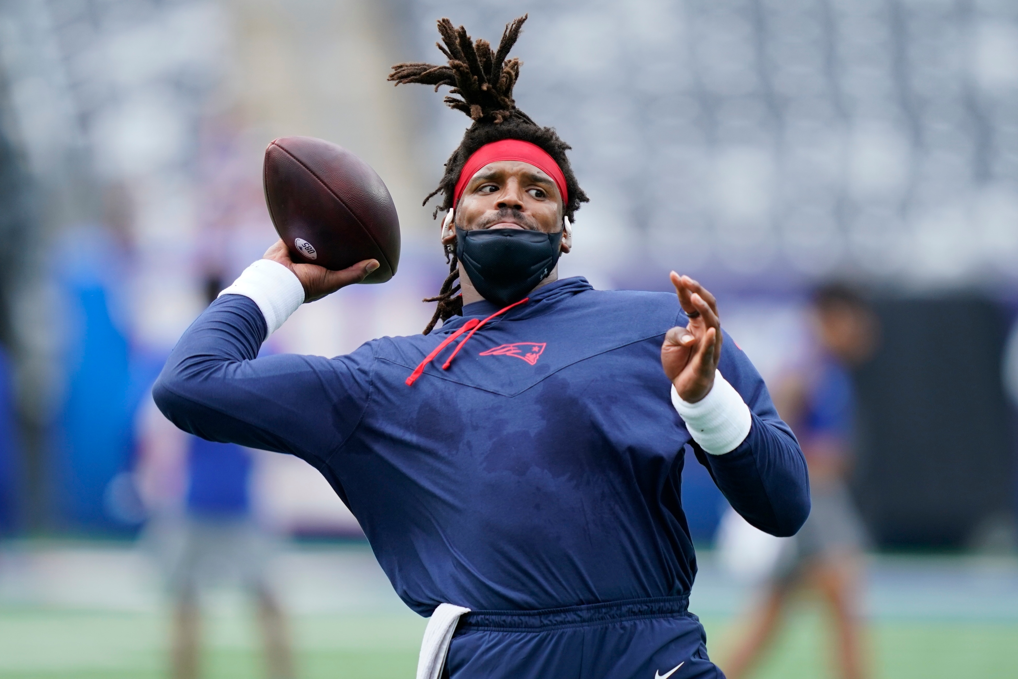New England Patriots quarterback Cam Newton warms up before an NFL preseason football game against the New York Giants Sunday, Aug. 29, 2021, in East Rutherford, N.J. (AP Photo/John Minchillo)