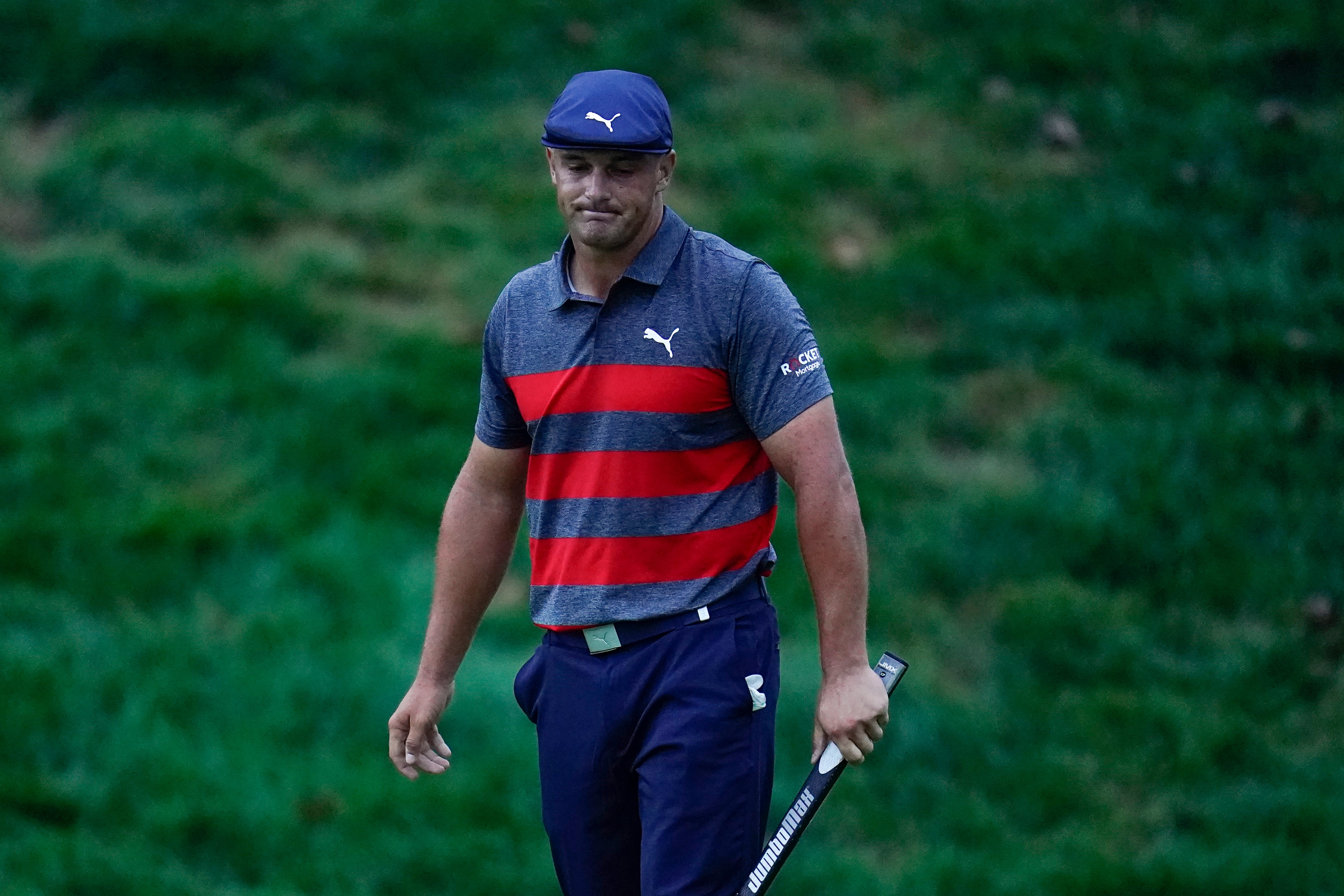 Bryson DeChambeau reacts after missing a putt on the 18th green, the sixth playoff hole during the final round of the BMW Championship golf tournament, to give Patrick Cantlay the victory, Sunday, Aug. 29, 2021, at Caves Valley Golf Club in Owings Mills, Md. (AP Photo/Julio Cortez)