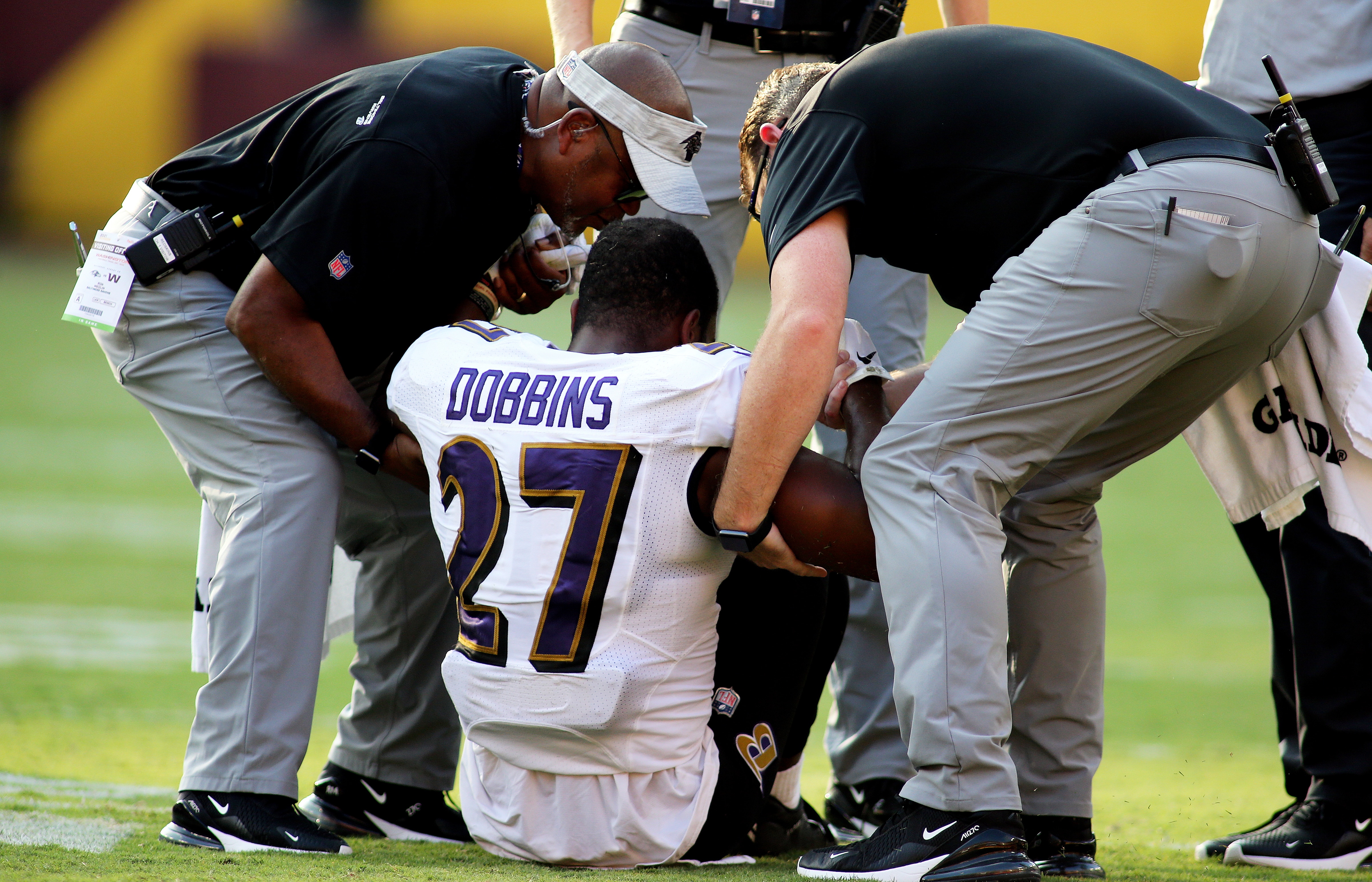 Baltimore Ravens running back J.K. Dobbins (27) is helped off the field during an NFL preseason football game against the Washington Football Team, Saturday, Aug. 28, 2021 in Landover, Md. (AP Photo/Daniel Kucin Jr.)