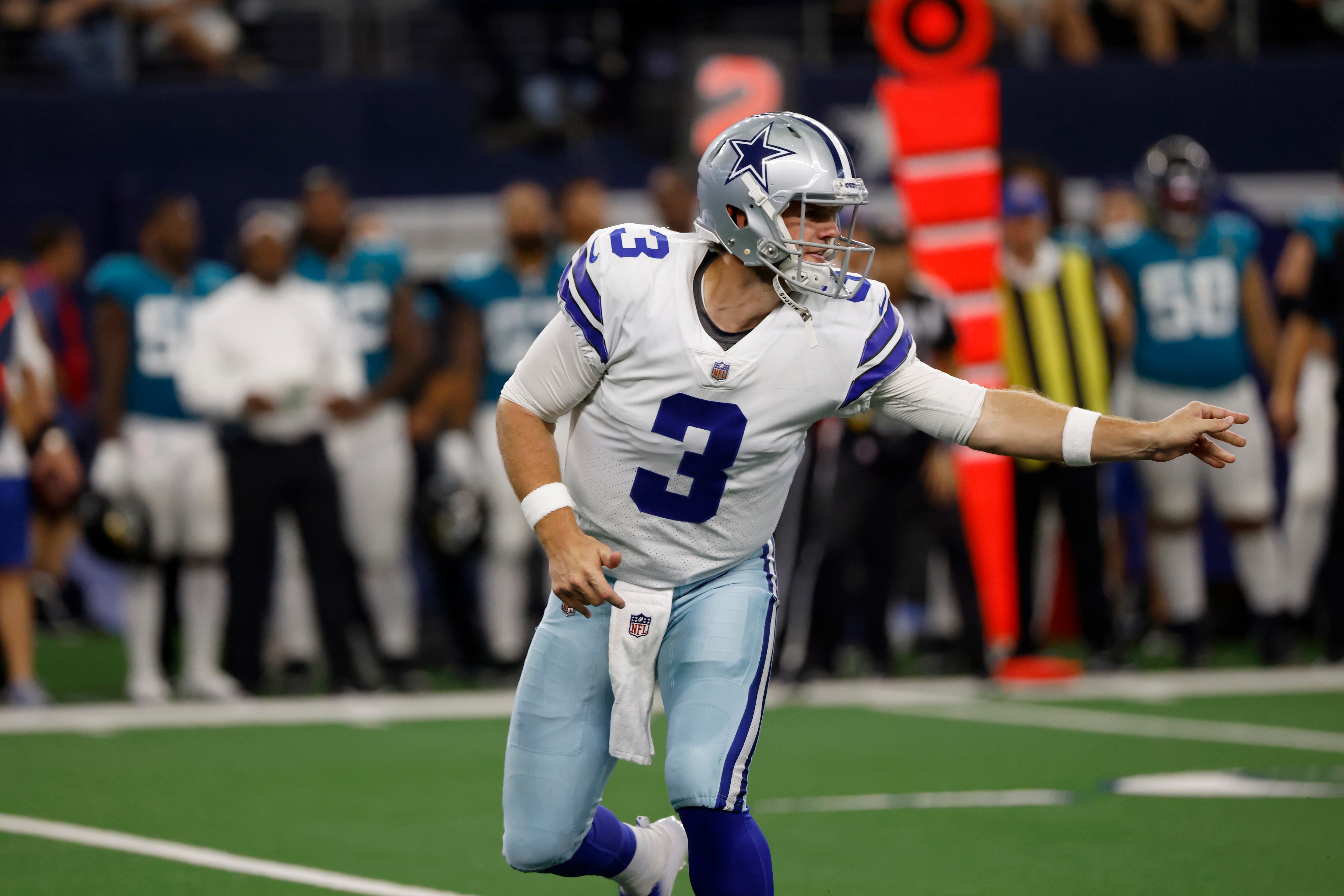 Dallas Cowboys quarterback Garrett Gilbert hands the ball off in the first half of a preseason NFL football game against the Jacksonville Jaguars in Arlington, Texas, Sunday, Aug. 29, 2021. (AP Photo/Ron Jenkins)