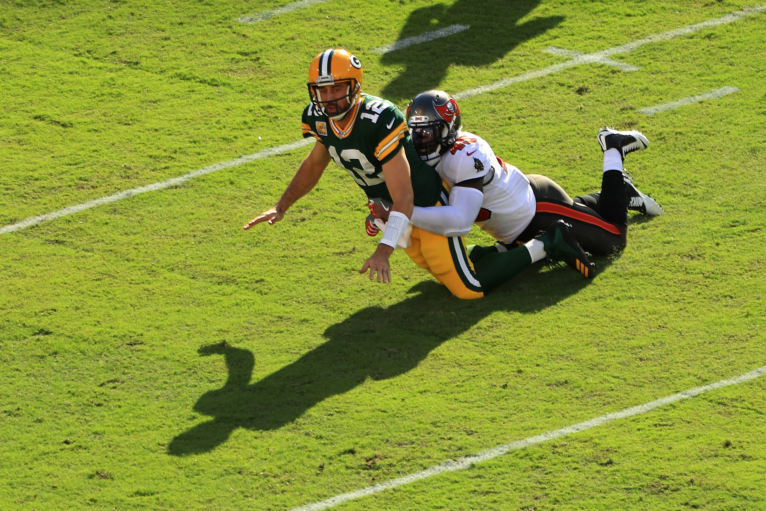 TAMPA, FLORIDA - OCTOBER 18: Aaron Rodgers #12 of the Green Bay Packers is tackled by Devin White #45 of the Tampa Bay Buccaneers during the first quarter at Raymond James Stadium on October 18, 2020 in Tampa, Florida. (Photo by Mike Ehrmann/Getty Images)