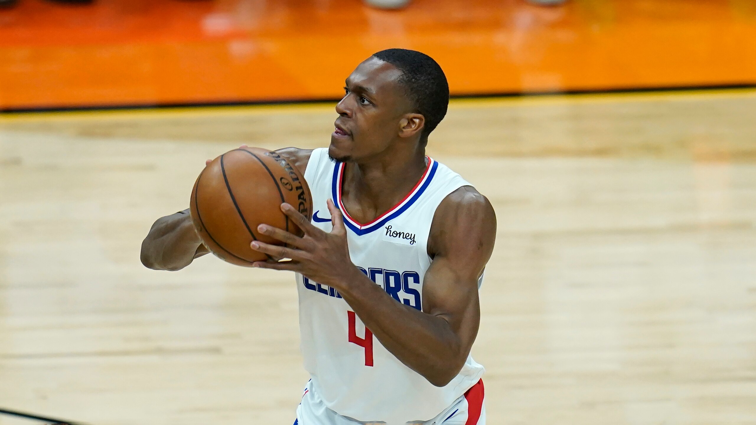 Los Angeles Clippers guard Rajon Rondo shoots a 3-pointer against the Phoenix Suns during the second half of Game 1 of the NBA basketball Western Conference finals Sunday, June 20, 2021, in Phoenix. The Suns defeated the Clippers 120-114. (AP Photo/Ross D. Franklin)