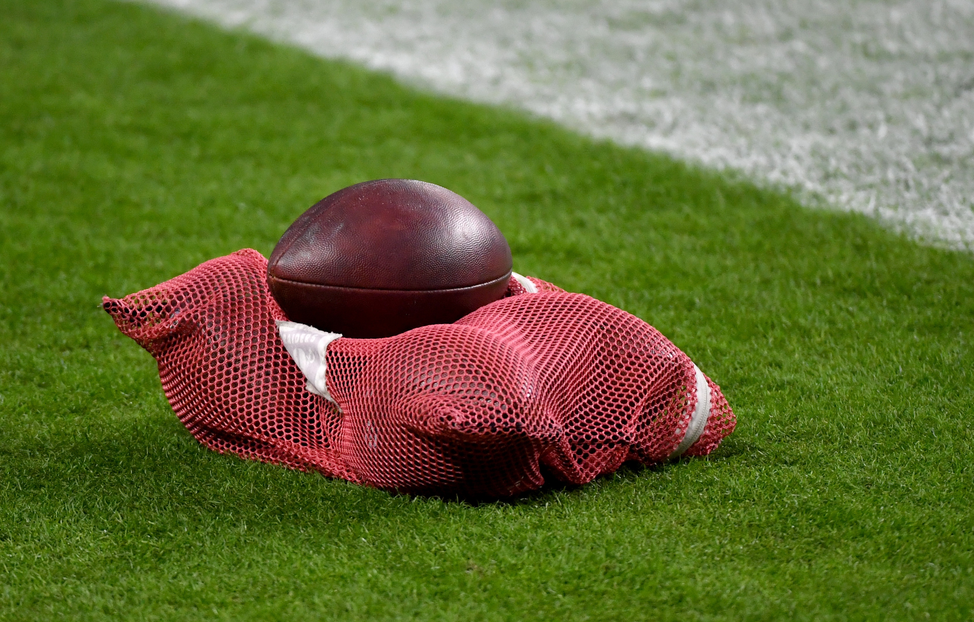 LAS VEGAS, NEVADA - DECEMBER 17:  A mesh bag of footballs is shown on the Las Vegas Raiders sideline before the team's game against the Los Angeles Chargers at Allegiant Stadium on December 17, 2020 in Las Vegas, Nevada. The Chargers defeated the Raiders 30-27 in overtime.  (Photo by Ethan Miller/Getty Images)