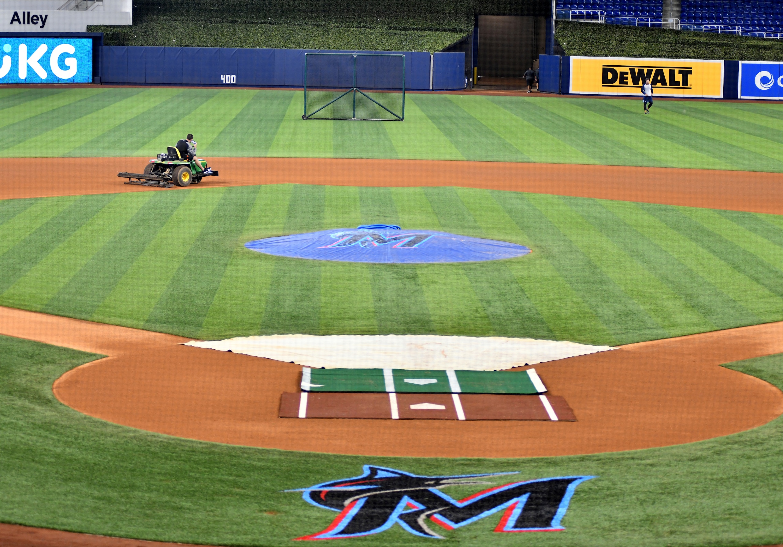 Members of the grounds crew prepare the infield at loanDepot park before the opening day baseball game between the Tampa Bay Rays and the Miami Marlins, Thursday, April 1, 2021, in Miami. (AP Photo/Gaston De Cardenas)