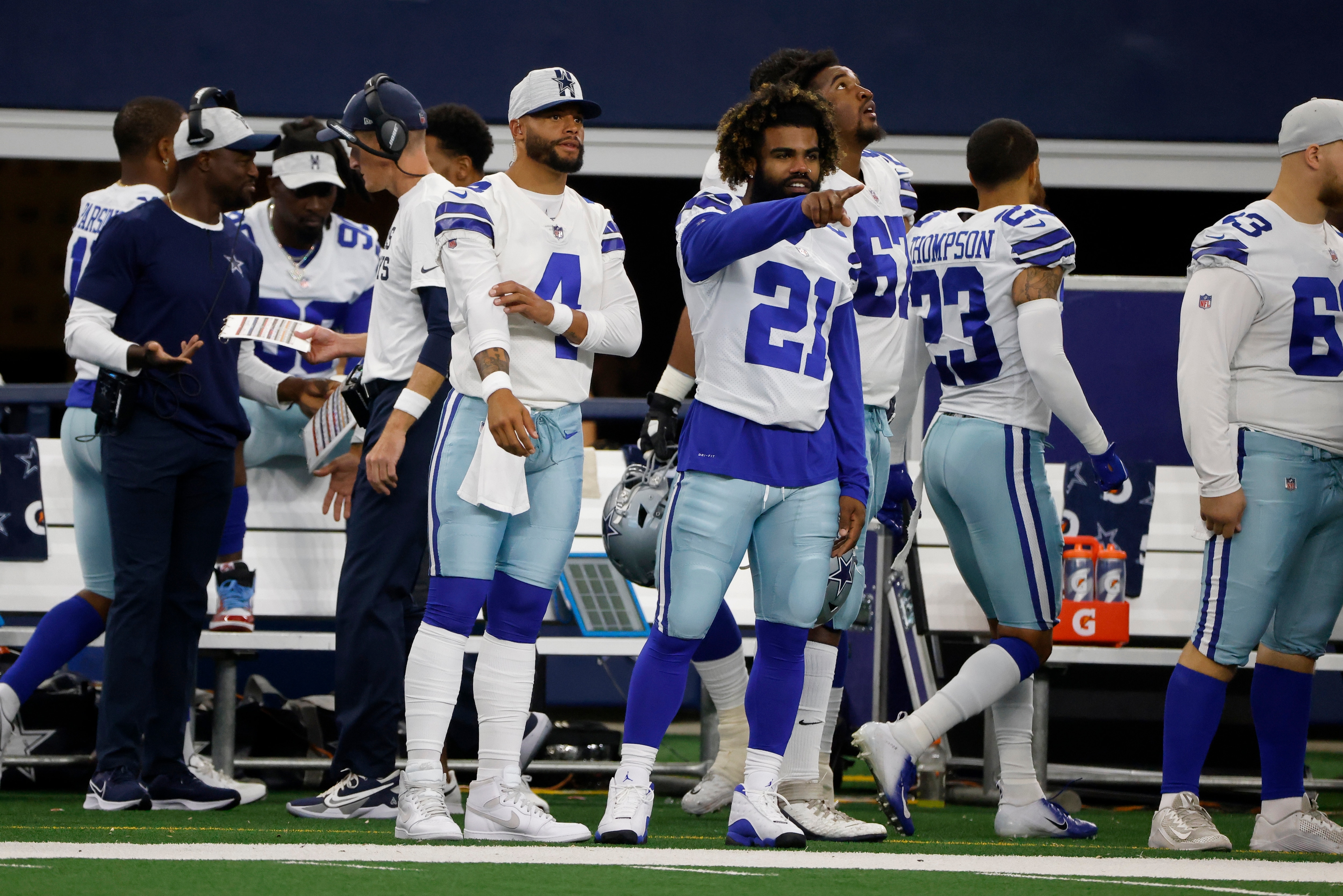 Dallas Cowboys quarterback Dak Prescott (4) and running back Ezekiel Elliott (21) watch play in the first half of a preseason NFL football game against the Jacksonville Jaguars in Arlington, Texas, Sunday, Aug. 29, 2021. (AP Photo/Michael Ainsworth)