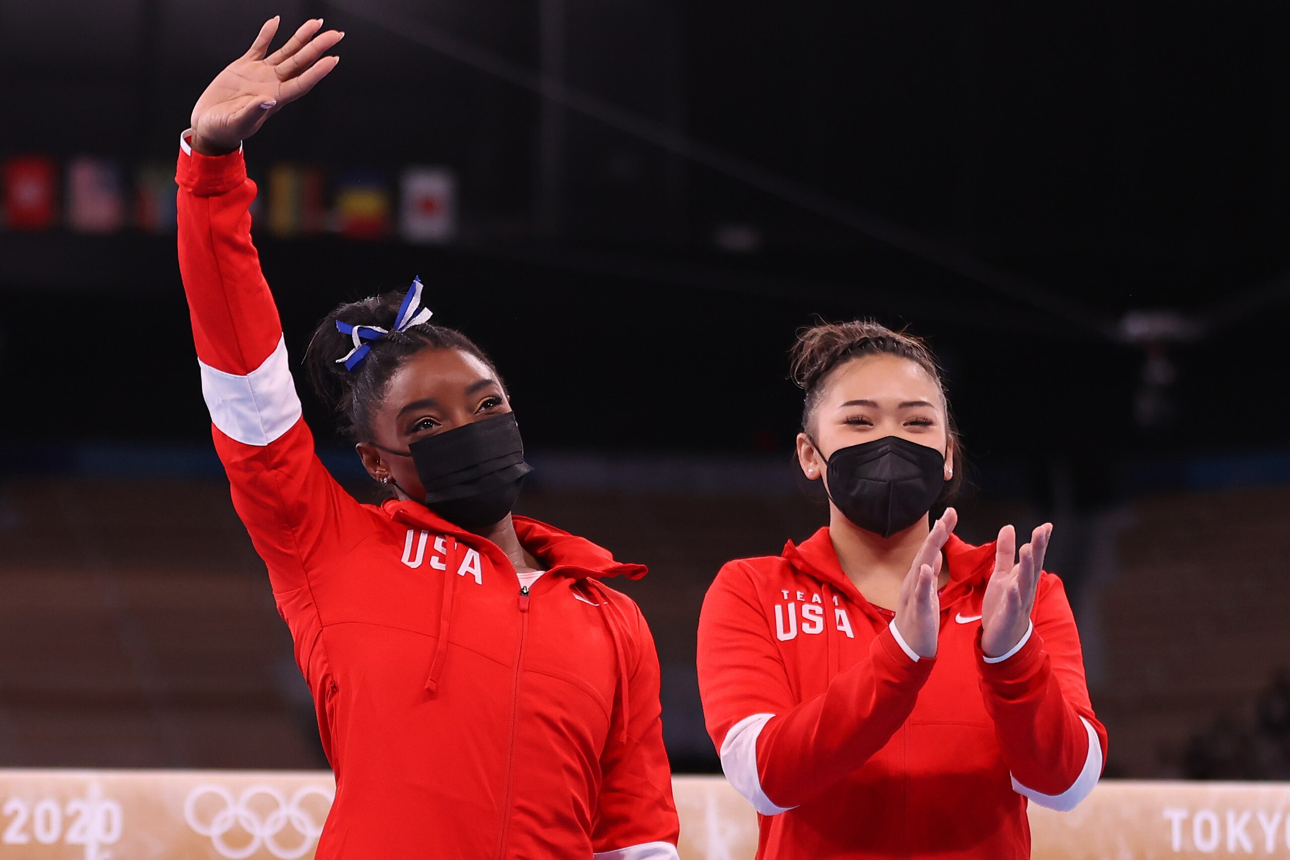 TOKYO, JAPAN - AUGUST 03: Simone Biles of Team United States acknowledges the crowd alongside teammate Sunisa Lee
prior to Women's Balance Beam Final on day eleven of the Tokyo 2020 Olympic Games at Ariake Gymnastics Centre on August 03, 2021 in Tokyo, Japan. (Photo by Laurence Griffiths/Getty Images) TOKYO, JAPAN - AUGUST 03: Simone Biles of Team United States acknowledges the crowd alongside teammate Sunisa Lee
prior to Women's Balance Beam Final on day eleven of the Tokyo 2020 Olympic Games at Ariake Gymnastics Centre on August 03, 2021 in Tokyo, Japan. (Photo by Laurence Griffiths/Getty Images)