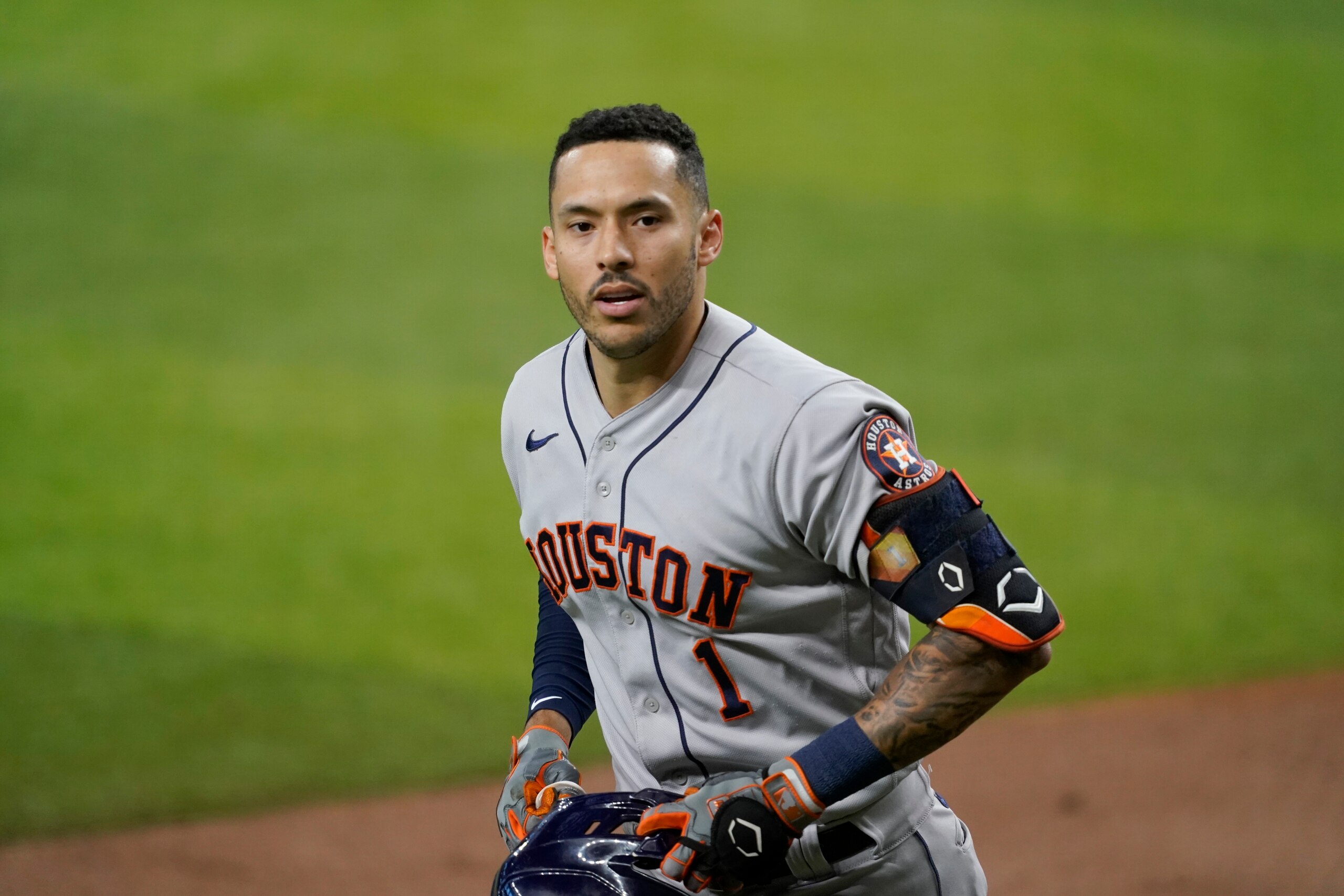Houston Astros' Carlos Correa celebrates his solo home run in the third inning of a baseball game against the Texas Rangers in Arlington, Texas, Saturday, Aug. 28, 2021. (AP Photo/Tony Gutierrez)