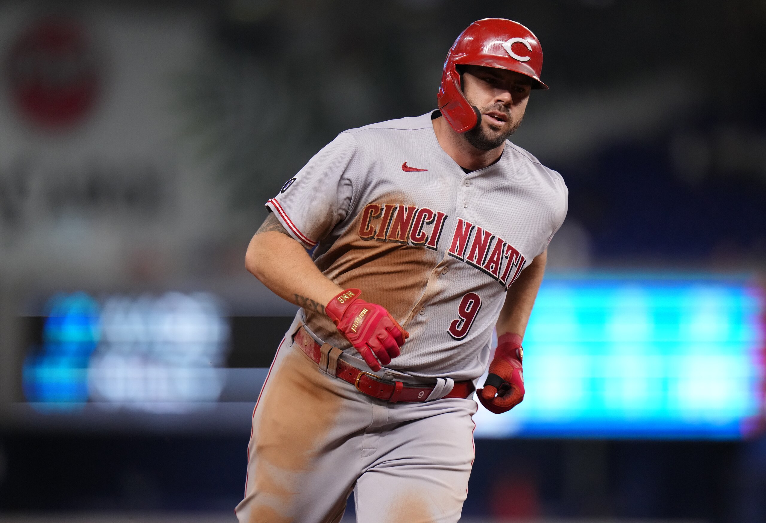 MIAMI, FLORIDA - AUGUST 27: Mike Moustakas #9 of the Cincinnati Reds runs the bases after hitting a solo homerun in the eighth inning against the Miami Marlins at loanDepot park on August 27, 2021 in Miami, Florida. (Photo by Mark Brown/Getty Images)