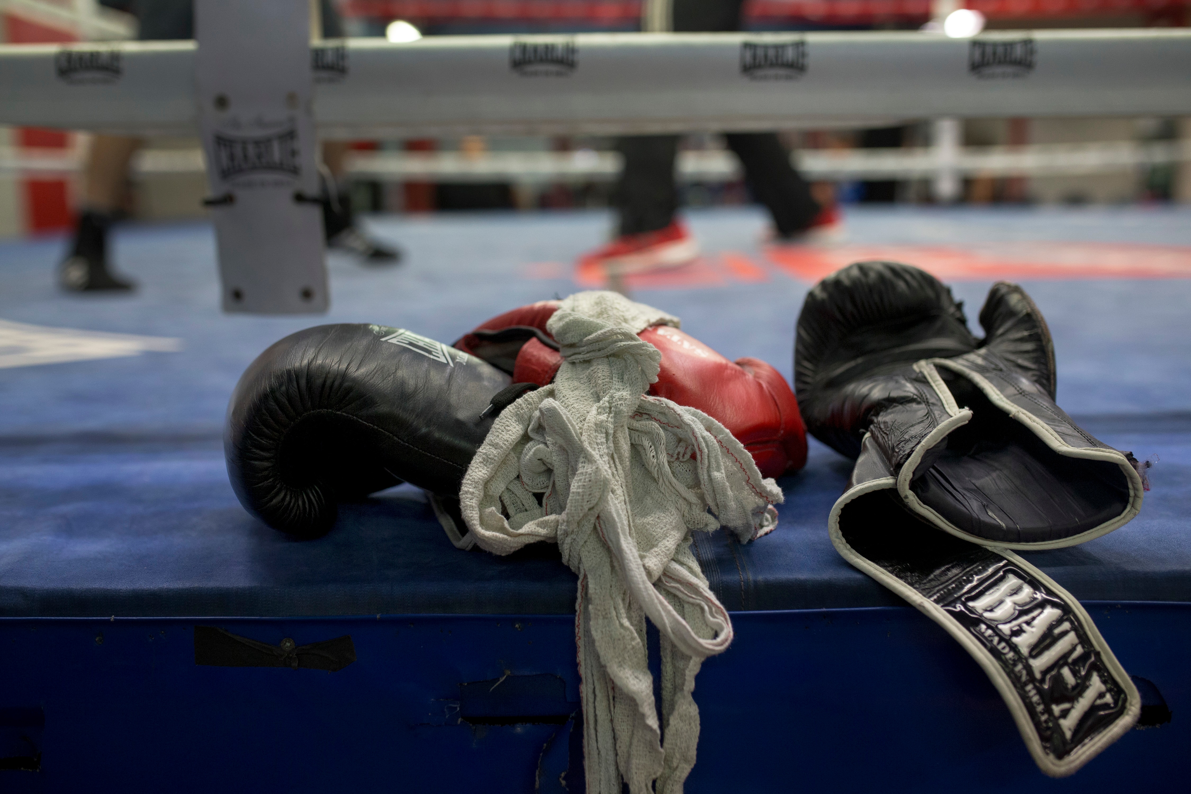 In this Friday, April 29, 2016 photo, boxing gloves lie on a boxing ring as boxers work out at El Rayo boxing gym in Madrid, Spain.  At 84, Manolo del Rio is something of a legend in Spanish boxing circles, having spent more than 65 years training some of the country's best fighters and pledging to keep on going until he drops. (AP Photo/Francisco Seco)