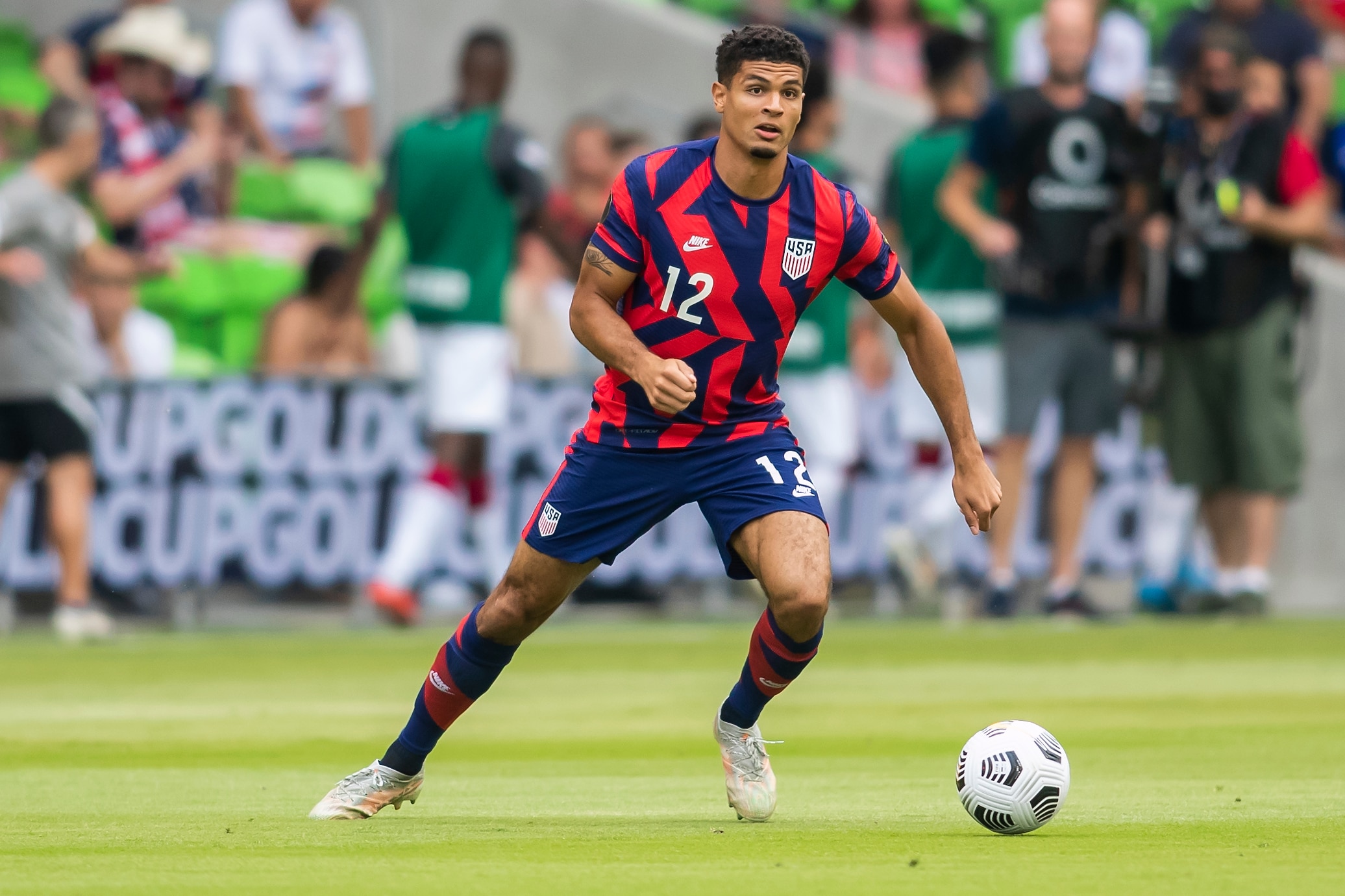 AUSTIN, TX - JULY 29: United States defender Miles Robinson (12) looks for a teammate to pass the ball to during the Gold Cup semifinal match between the United States and Qatar on Thursday July 29th, 2021 at Q2 stadium in Austin,TX.  (Photo by Nick Tre. Smith/Icon Sportswire via Getty Images)