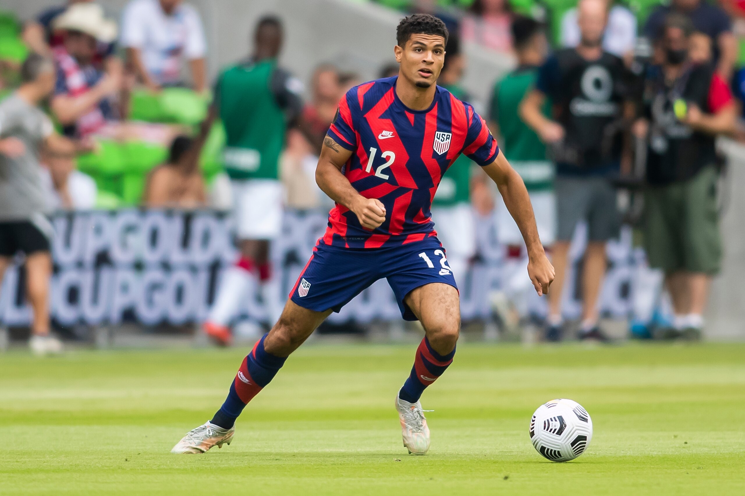 AUSTIN, TX - JULY 29: United States defender Miles Robinson (12) looks for a teammate to pass the ball to during the Gold Cup semifinal match between the United States and Qatar on Thursday July 29th, 2021 at Q2 stadium in Austin,TX.  (Photo by Nick Tre. Smith/Icon Sportswire via Getty Images)