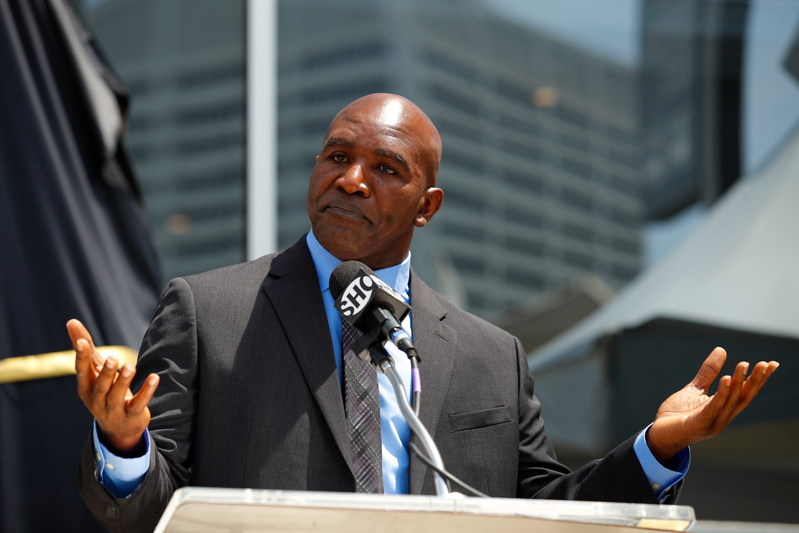 ATLANTA, GA - JUNE 25: Evander Holyfield speaks at the podium during the unveiling of his statue at State Farm Arena on June 25, 2021 in Atlanta, Georgia. (Photo by Todd Kirkland/Getty Images)