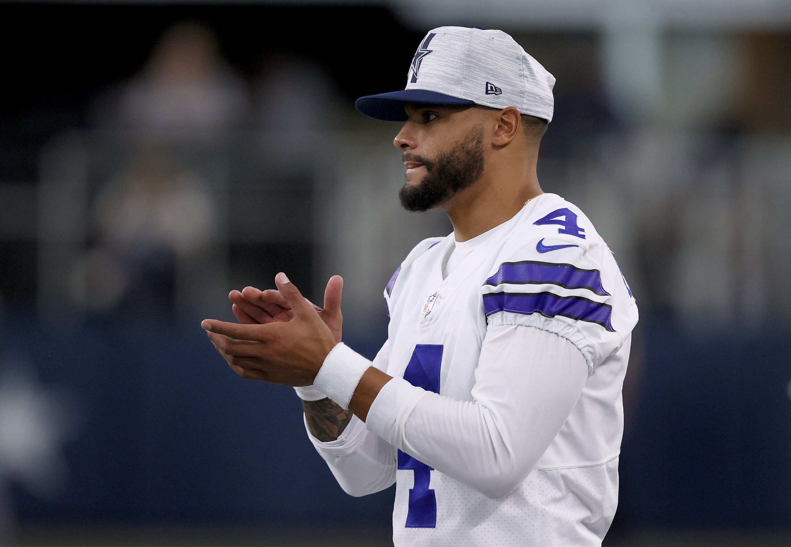ARLINGTON, TEXAS - AUGUST 21: Quarterback Dak Prescott #4 of the Dallas Cowboys looks on from the sidelines as the Dallas Cowboys take on the Houston Texans in the first quarter of a preseason NFL game at AT&T Stadium on August 21, 2021 in Arlington, Texas. (Photo by Tom Pennington/Getty Images) ARLINGTON, TEXAS - AUGUST 21: Quarterback Dak Prescott #4 of the Dallas Cowboys looks on from the sidelines as the Dallas Cowboys take on the Houston Texans in the first quarter of a preseason NFL game at AT&T Stadium on August 21, 2021 in Arlington, Texas. (Photo by Tom Pennington/Getty Images)