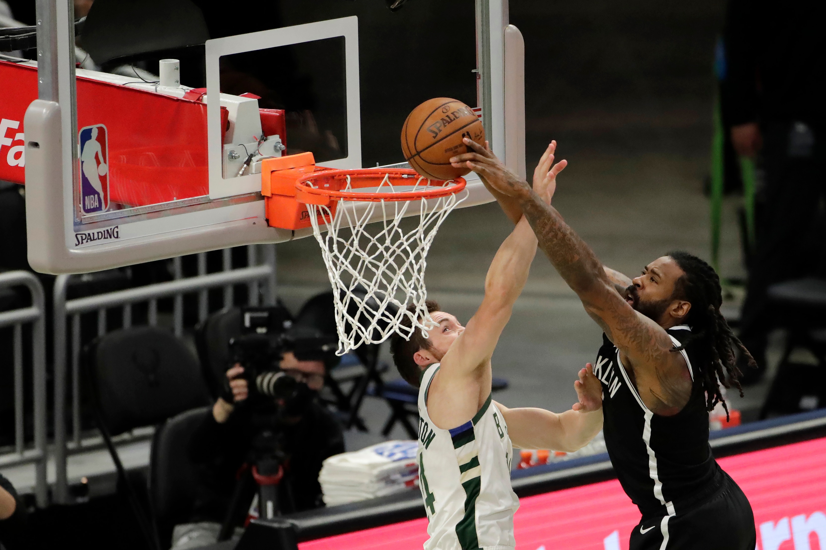 Brooklyn Nets' DeAndre Jordan is fouled by Milwaukee Bucks' Pat Connaughton as he attempts a shot during the first half of an NBA basketball game Tuesday, May 4, 2021, in Milwaukee. (AP Photo/Aaron Gash)