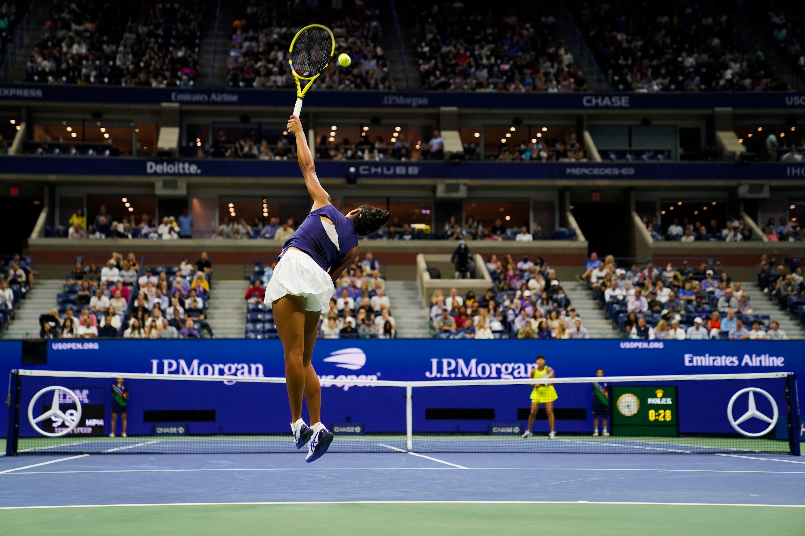 Leylah Fernandez, left, of Canada, serves to Naomi Osaka, of Japan, during the third round of the US Open tennis championships, Friday, Sept. 3, 2021, in New York. (AP Photo/John Minchillo)