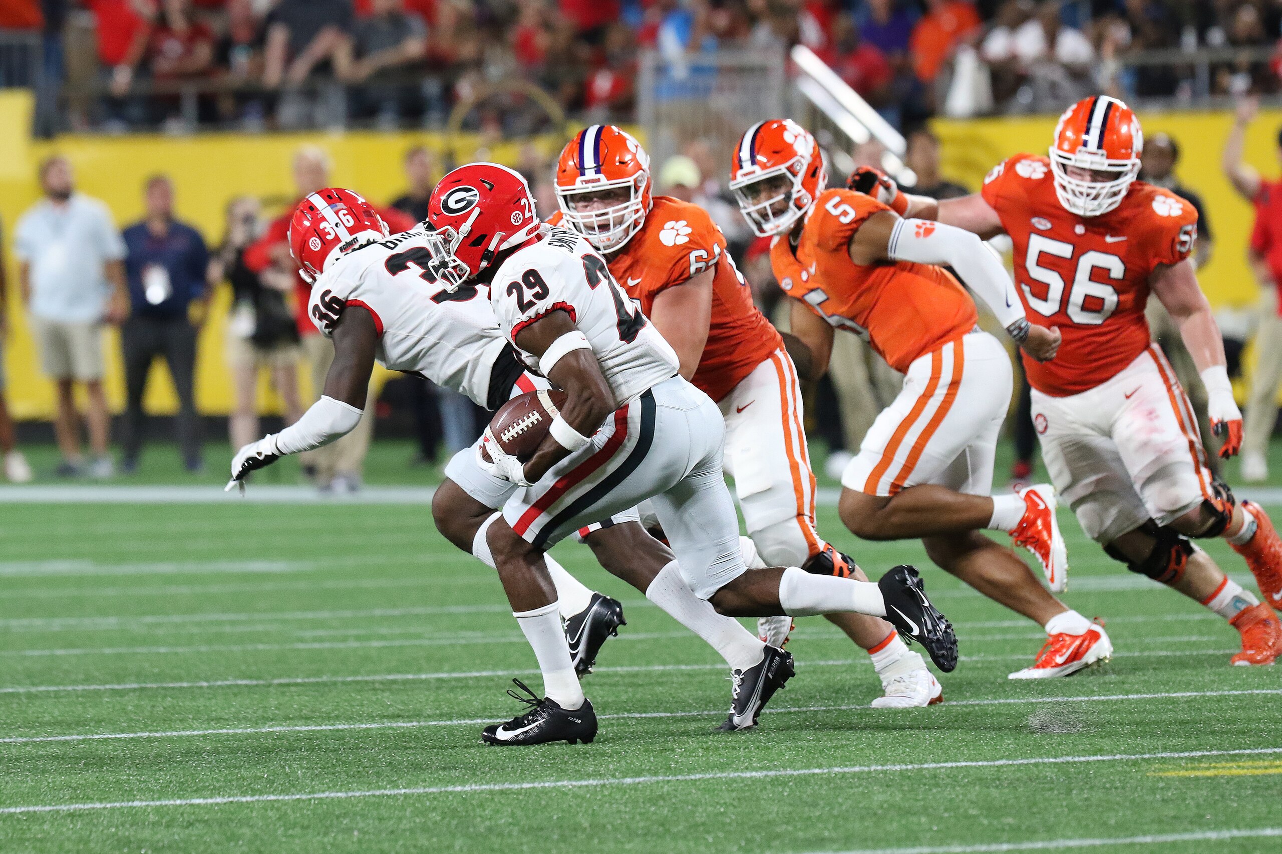 CHARLOTTE, NC - SEPTEMBER 04: Christopher Smith (29) defensive back of Georgia on his way to score a touchdown after making an interception during the Duke's Mayo Classic college football game between the Georgia Bulldogs and the Clemson Tiger on September 4, 2012, at Bank of America Stadium in Charlotte, N.C. (Photo by John Byrum/Icon Sportswire via Getty Images) CHARLOTTE, NC - SEPTEMBER 04: Christopher Smith (29) defensive back of Georgia on his way to score a touchdown after making an interception during the Duke's Mayo Classic college football game between the Georgia Bulldogs and the Clemson Tiger on September 4, 2012, at Bank of America Stadium in Charlotte, N.C. (Photo by John Byrum/Icon Sportswire via Getty Images)