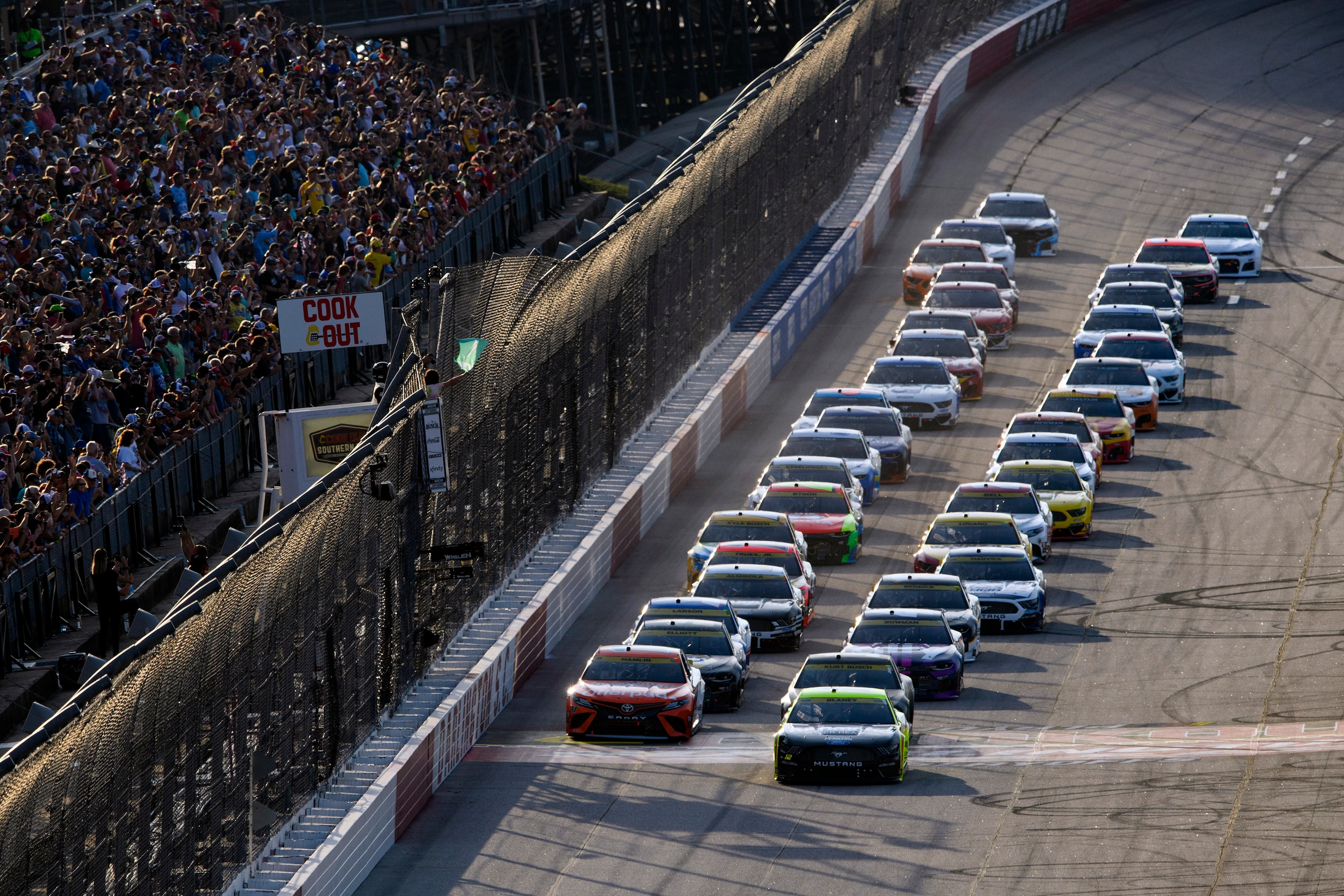 Ryan Blaney, front right, and Denny Hamlin, front left, lead the start of a NASCAR Cup Series auto race Sunday, Sept. 5, 2021, in Darlington, S.C. (AP Photo/John Amis)