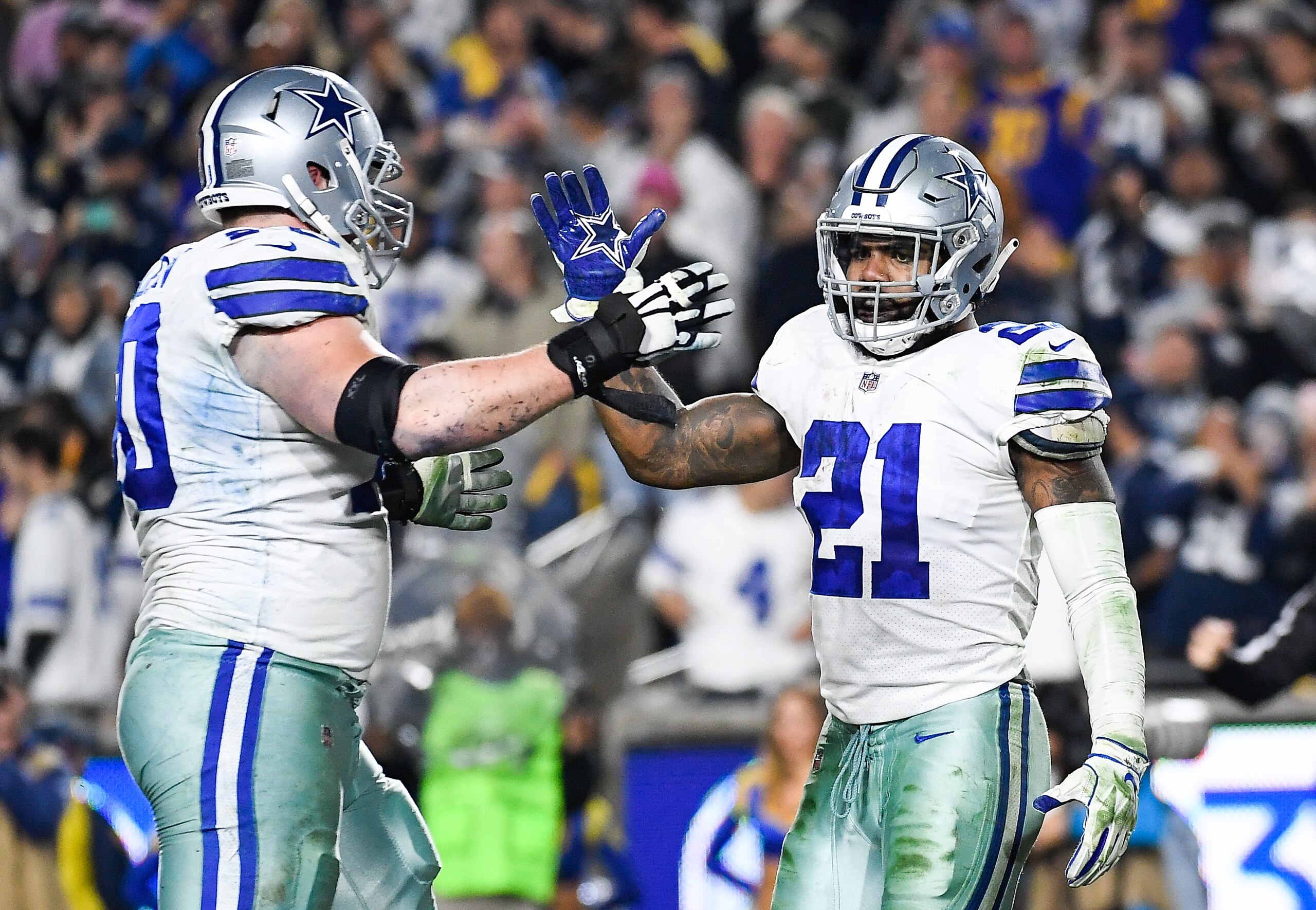 LOS ANGELES, CA - JANUARY 12: Running back Ezekiel Elliott #21 of the Dallas Cowboys celebrates his touchdown with offensive guard Zack Martin #70 in the third quarter against the Los Angeles Rams in the NFC Divisional Round playoff game at Los Angeles Memorial Coliseum on January 12, 2019 in Los Angeles, California. (Photo by Kevork Djansezian/Getty Images) LOS ANGELES, CA - JANUARY 12: Running back Ezekiel Elliott #21 of the Dallas Cowboys celebrates his touchdown with offensive guard Zack Martin #70 in the third quarter against the Los Angeles Rams in the NFC Divisional Round playoff game at Los Angeles Memorial Coliseum on January 12, 2019 in Los Angeles, California. (Photo by Kevork Djansezian/Getty Images)