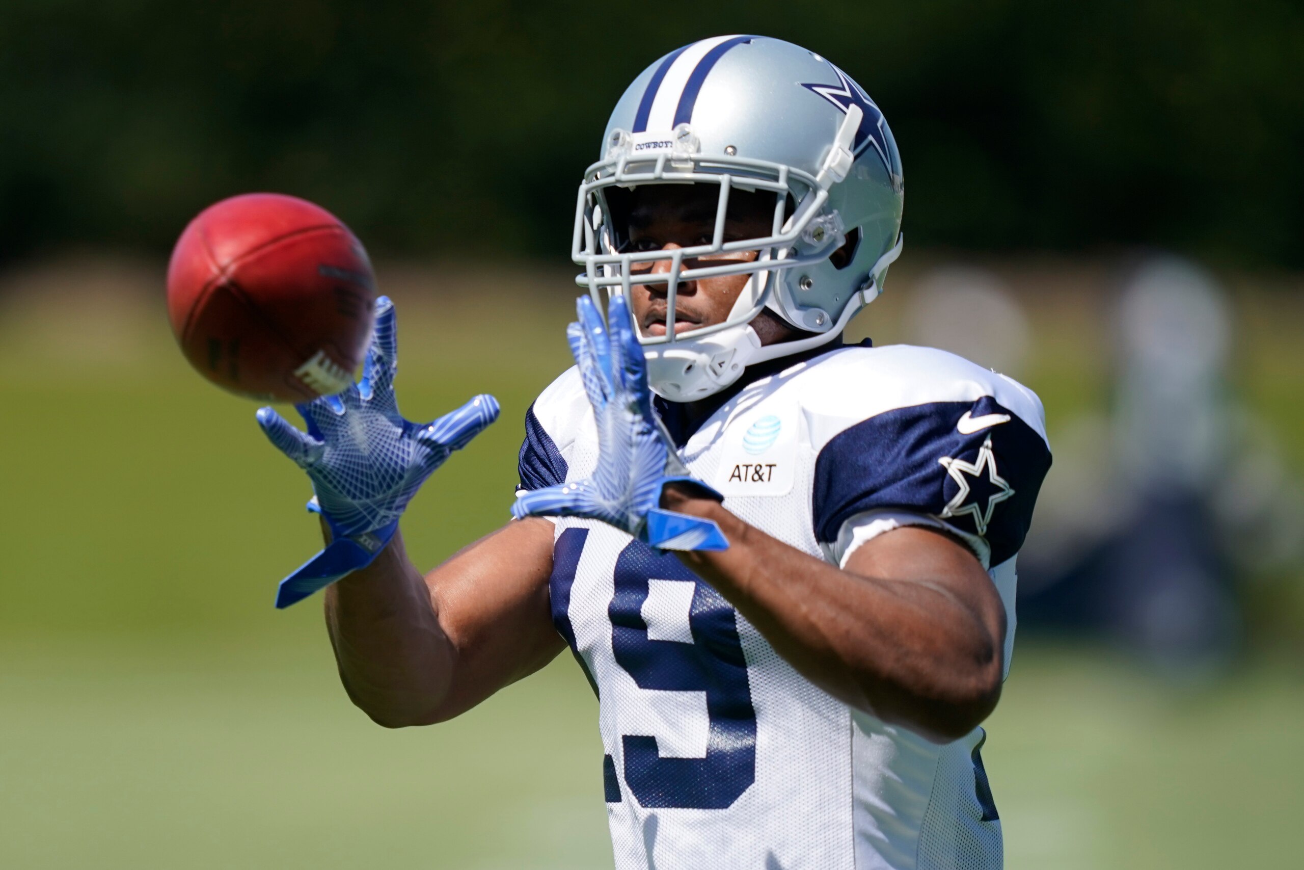 Dallas Cowboys wide receiver Amari Cooper (19) catches a pass during NFL football practice in Frisco, Texas, Tuesday, Aug. 24, 2021. (AP Photo/LM Otero)