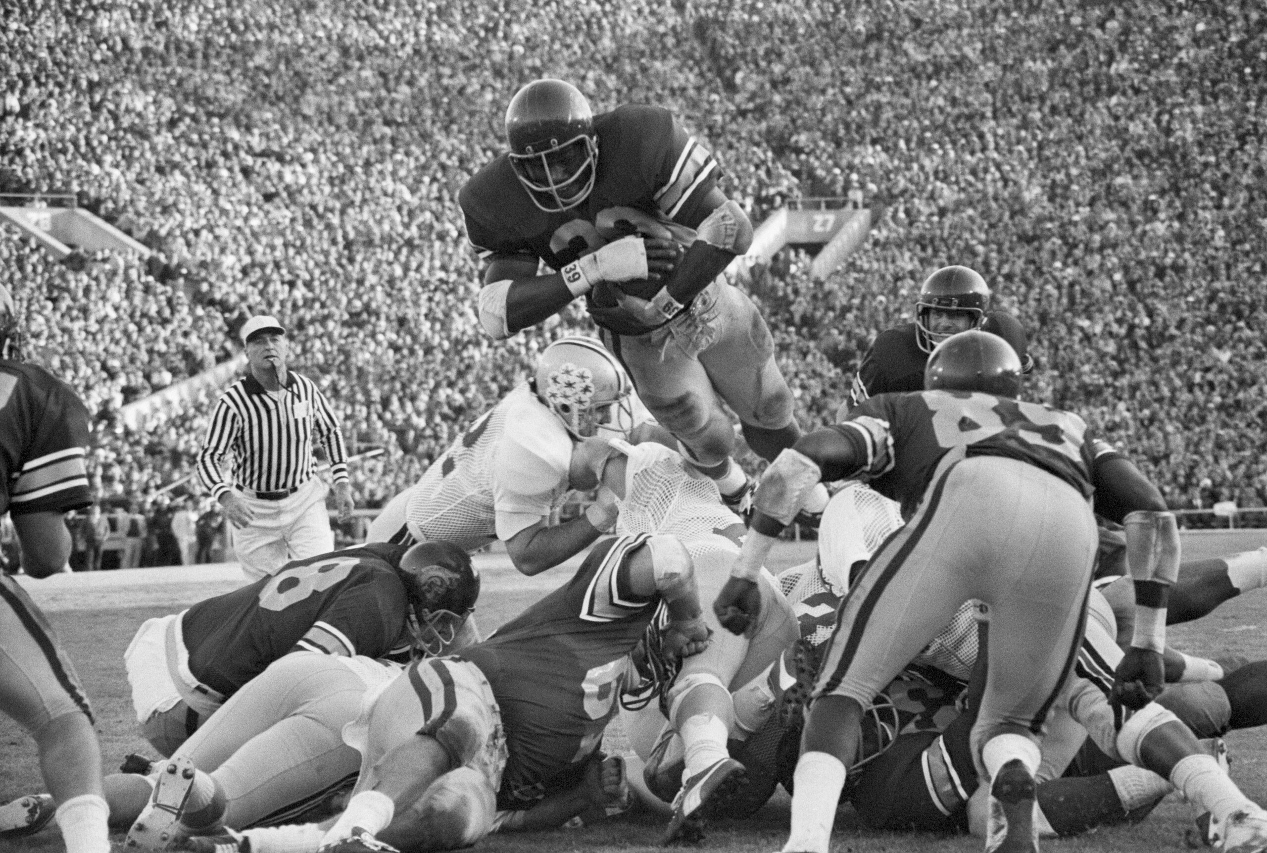 (Original Caption) Pasadena, Calif.: Sam (the Man) Cunningham shows his diving form which led him to a new Rose Bowl record of four touchdowns in a single Rose Bowl game by a single player. Cunningham scored four touchdowns against the Ohio State Buckeyes, all by diving over the goal line and a strongly assembled defense set op to stop him. The USC Trojans ran all over the Ohio State Buckeyes and won the 1973 Rose Bowl by a score of 42-17. 1/1/1973