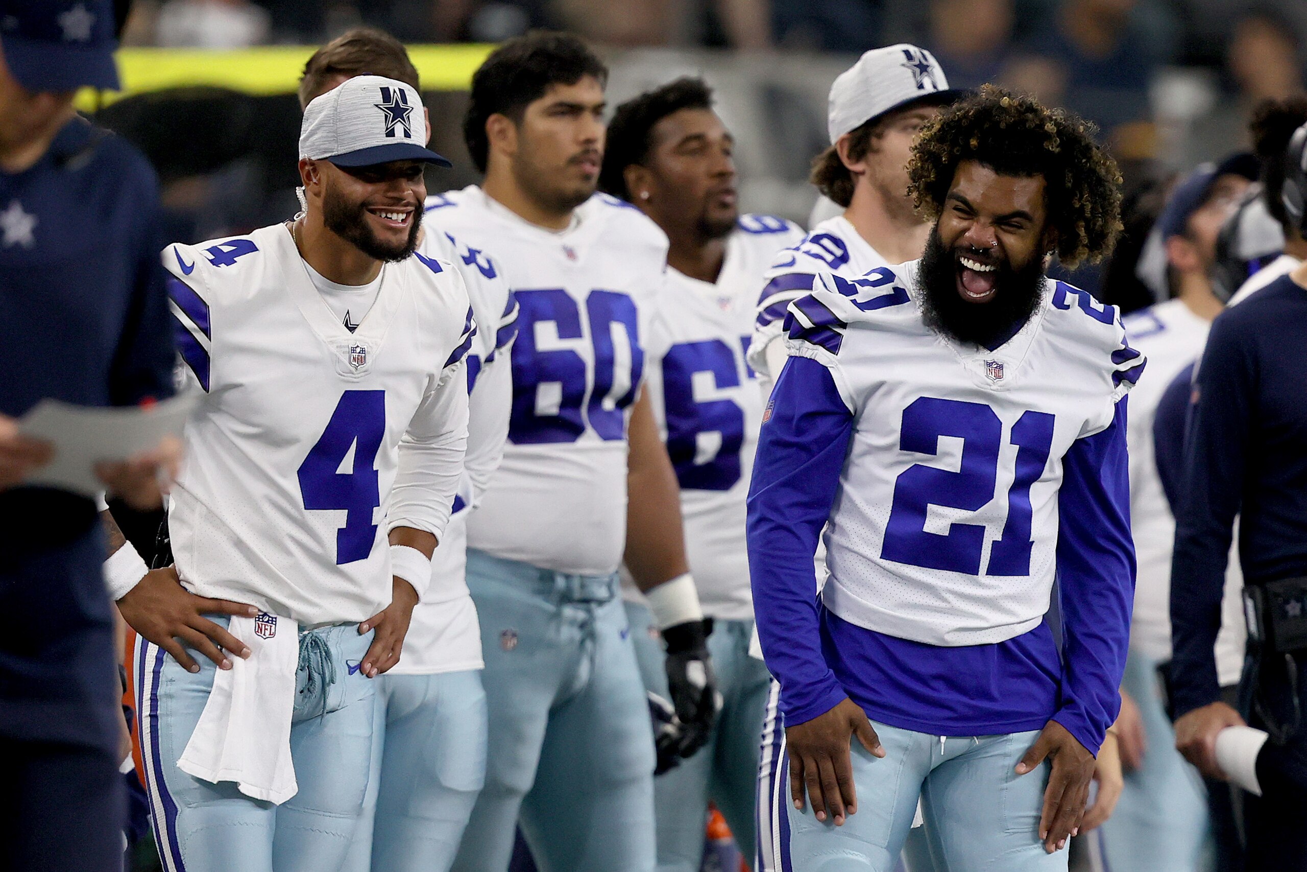 ARLINGTON, TEXAS - AUGUST 29: Quarterback Dak Prescott #4 of the Dallas Cowboys and running back Ezekiel Elliott #21 of the Dallas Cowboys looks on as the Dallas Cowboys take on the Jacksonville Jaguars during the second quarter of a NFL preseason football game at AT&T Stadium on August 29, 2021 in Arlington, Texas. (Photo by Tom Pennington/Getty Images)