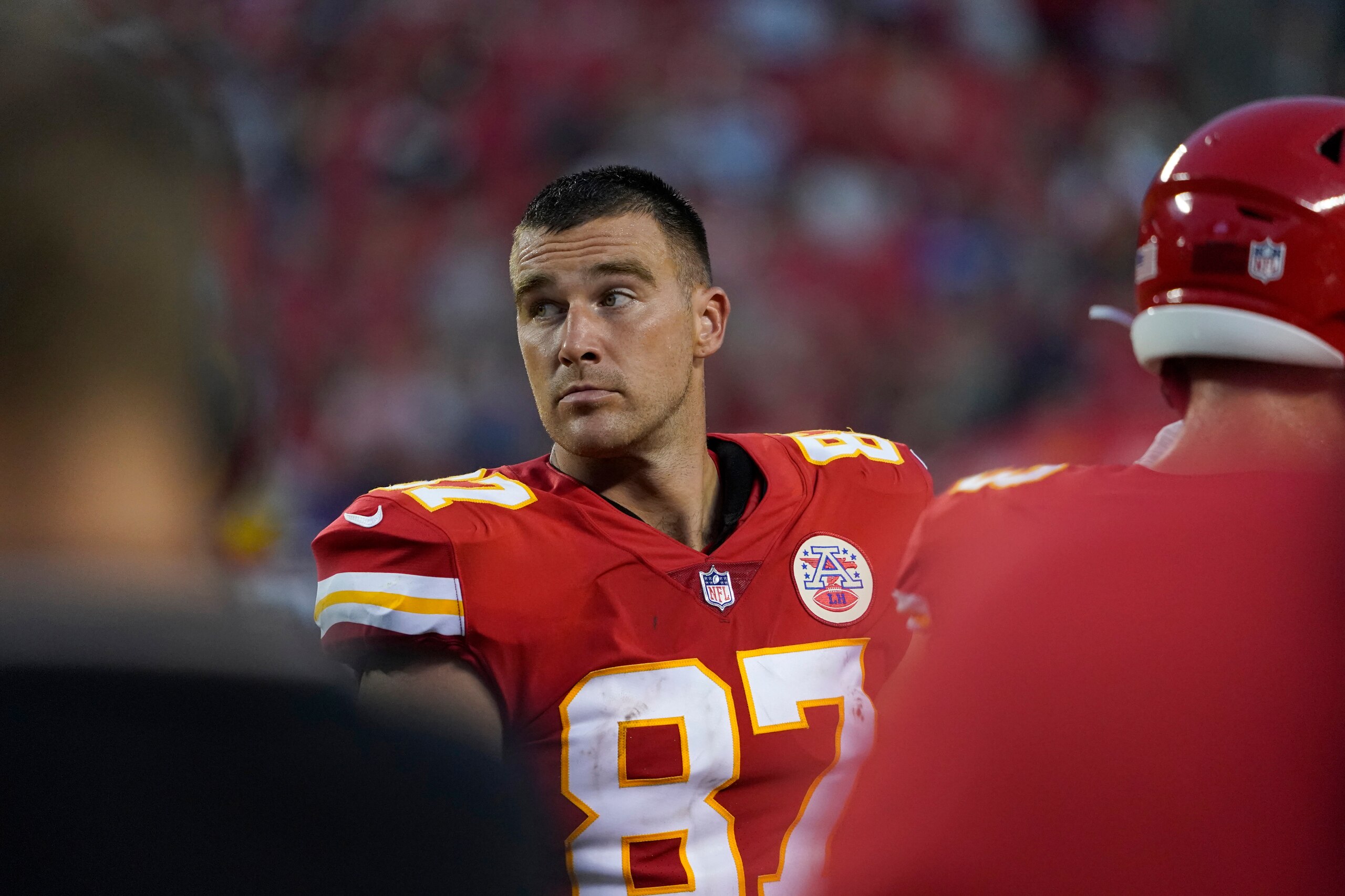 Kansas City Chiefs tight end Travis Kelce watches from the sidelines during the first half of an NFL football game against the Minnesota Vikings Friday, Aug. 27, 2021, in Kansas City, Mo. (AP Photo/Ed Zurga)