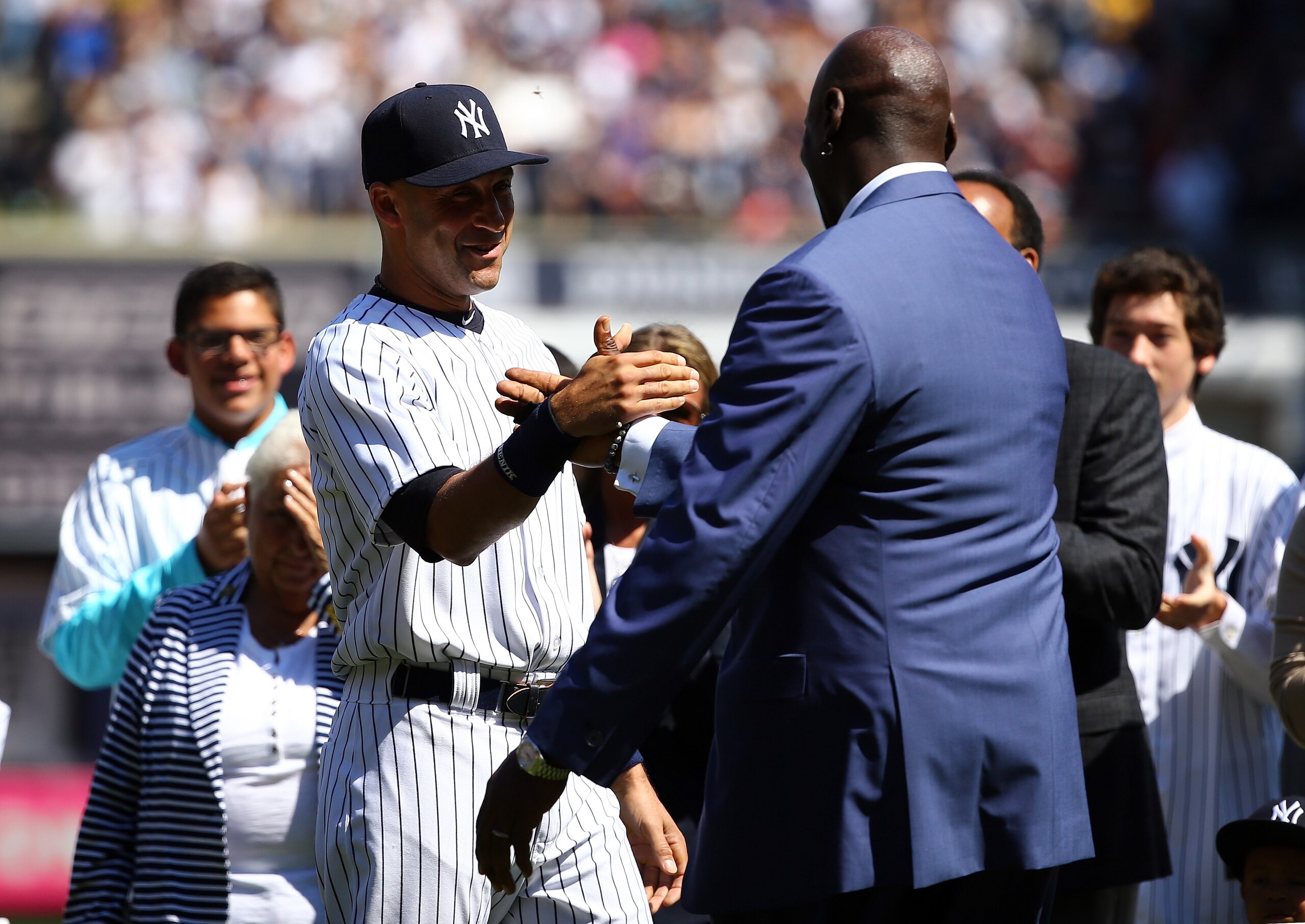 NEW YORK, NY - SEPTEMBER 07:  Derek Jeter #2 of the New York Yankees is greeted by basketball hall of famer Michael Jordan (R) during Derek Jeter Day on September 7, 2014 before the game between the New York Yankees and the Kansas City Royals at Yankee Stadium in the Bronx borough of New York City.  (Photo by Al Bello/Getty Images)