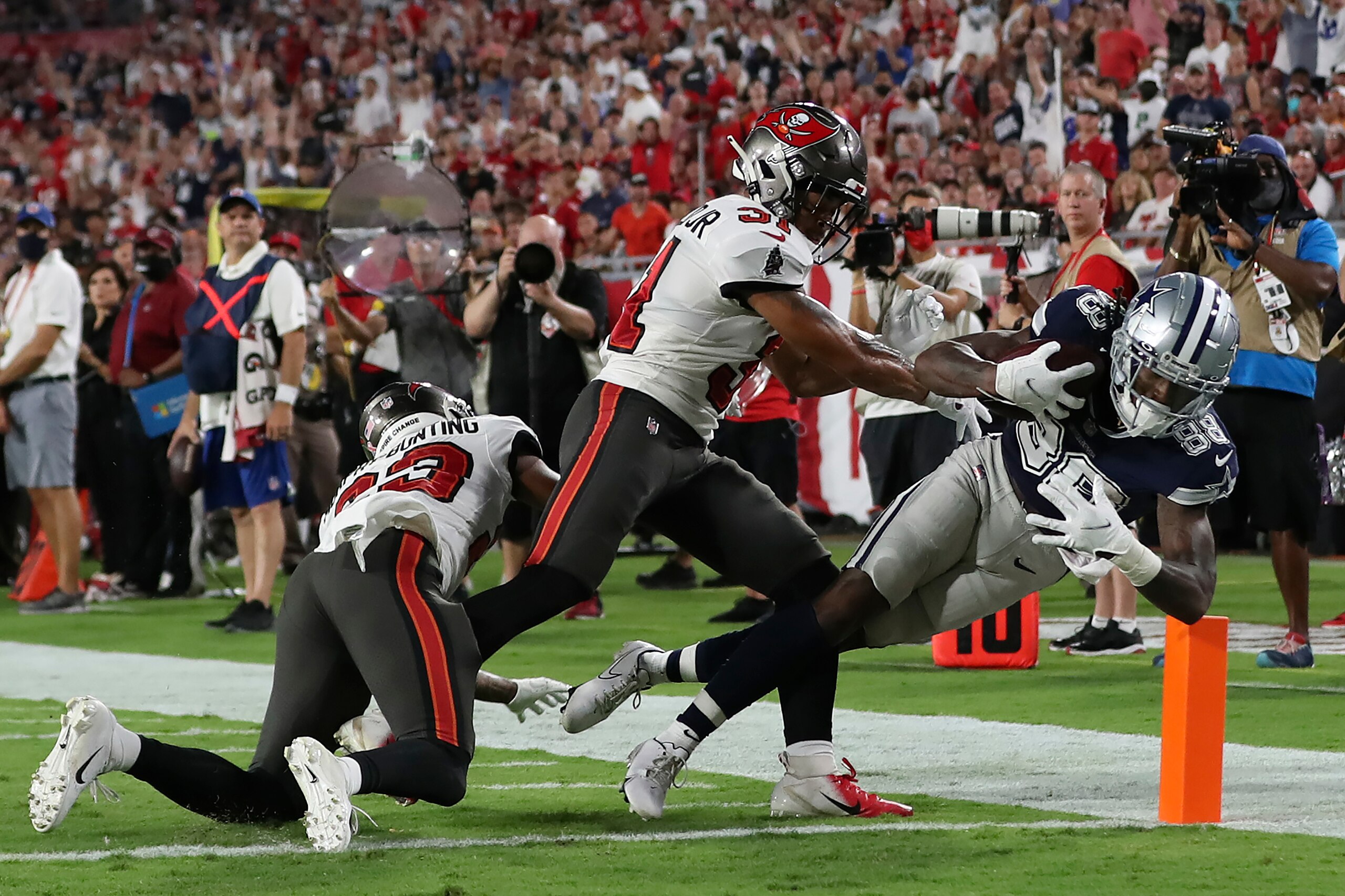 Dallas Cowboys wide receiver CeeDee Lamb (88) beats Tampa Bay Buccaneers cornerback Sean Murphy-Bunting (23) and safety Antoine Winfield Jr. (31) on a 22-yard touchdown reception during the first half of an NFL football game Thursday, Sept. 9, 2021, in Tampa, Fla. (AP Photo/Mark LoMoglio)
