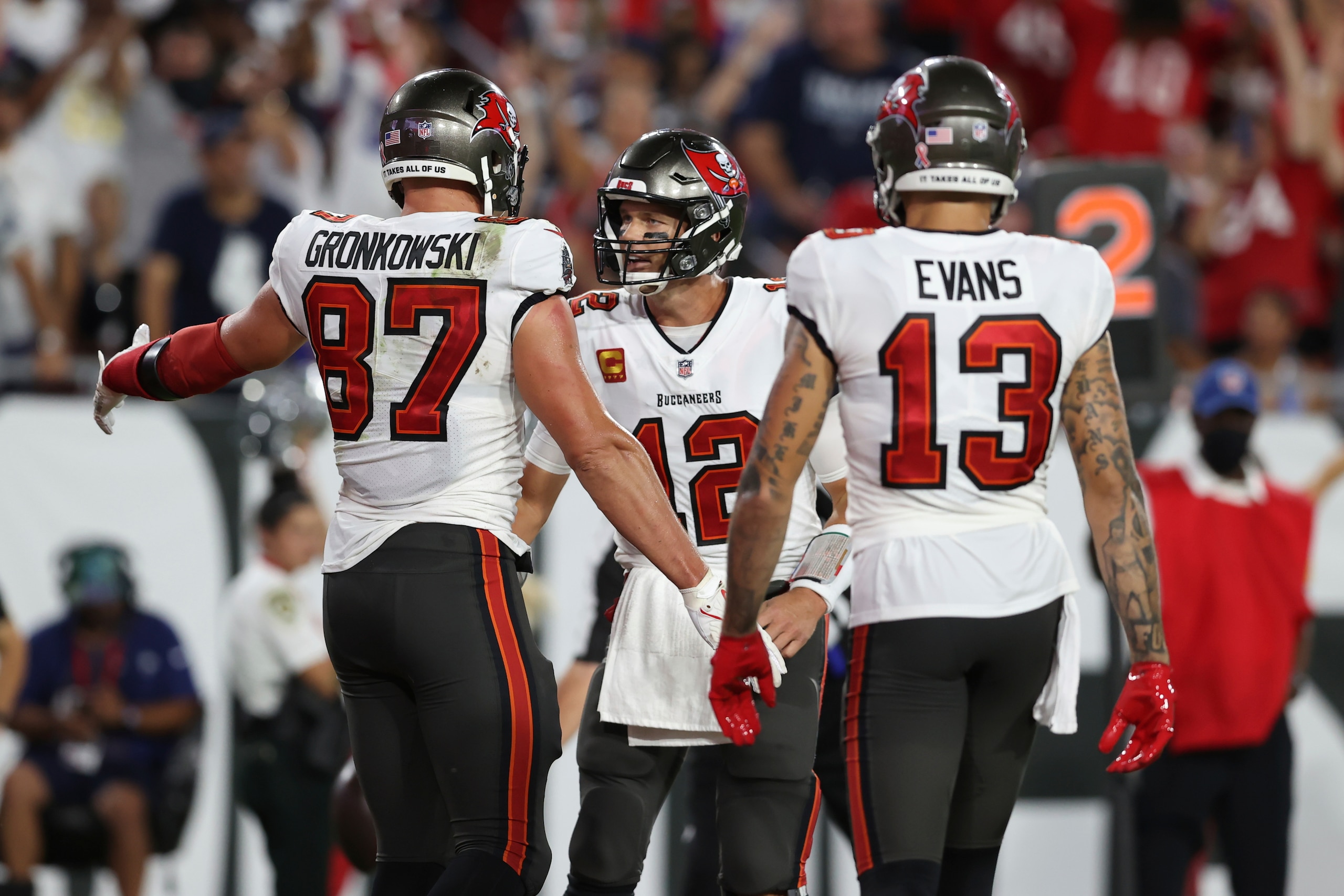 Tampa Bay Buccaneers tight end Rob Gronkowski (87) celebrates his score against the Dallas Cowboys with quarterback Tom Brady (12) and wide receiver Mike Evans (13) during the first half of an NFL football game Thursday, Sept. 9, 2021, in Tampa, Fla. (AP Photo/Mark LoMoglio)