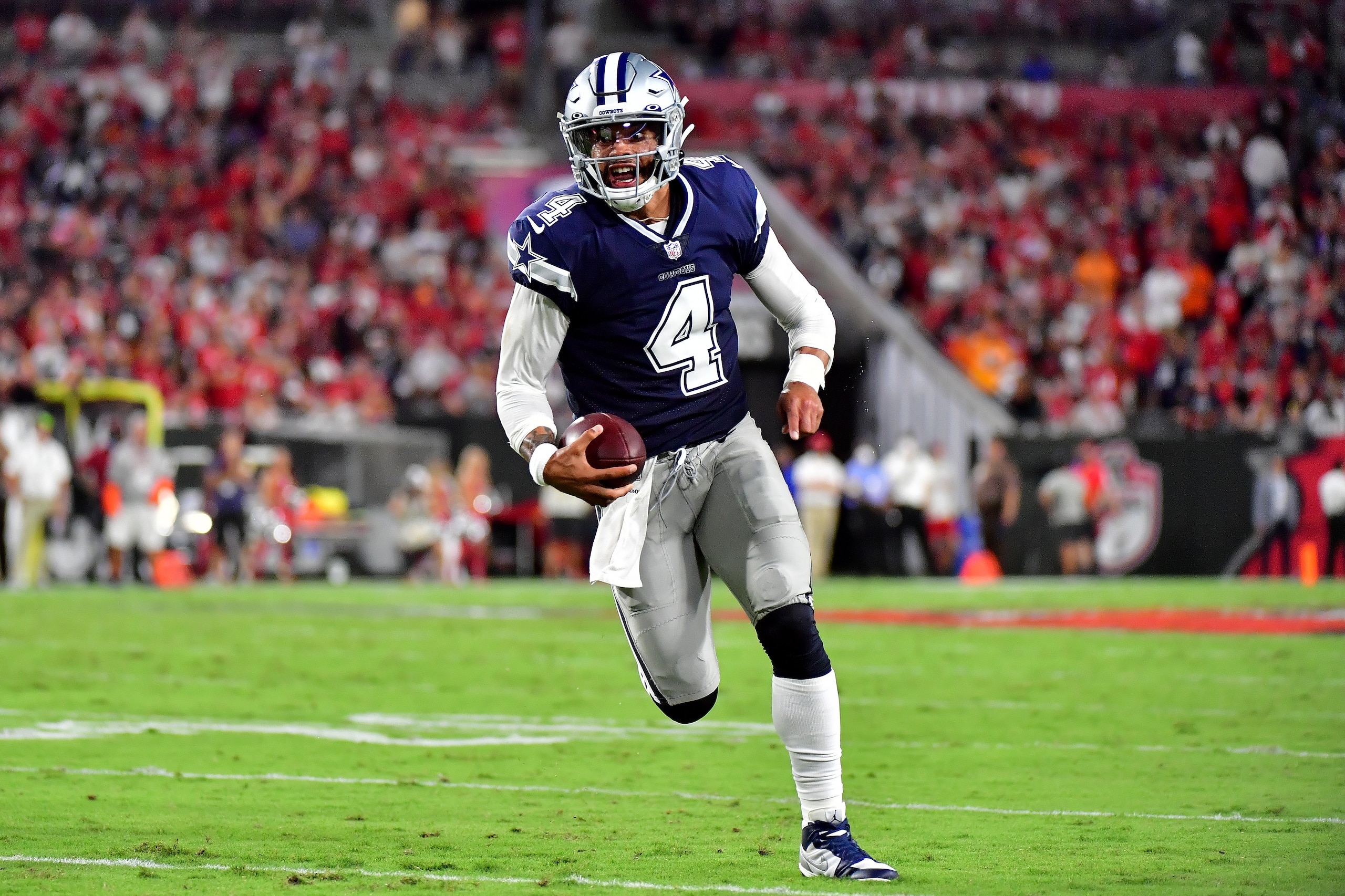 TAMPA, FLORIDA - SEPTEMBER 09: Dak Prescott #4 of the Dallas Cowboys carries the ball during the second quarter against the Tampa Bay Buccaneers at Raymond James Stadium on September 09, 2021 in Tampa, Florida. (Photo by Julio Aguilar/Getty Images)