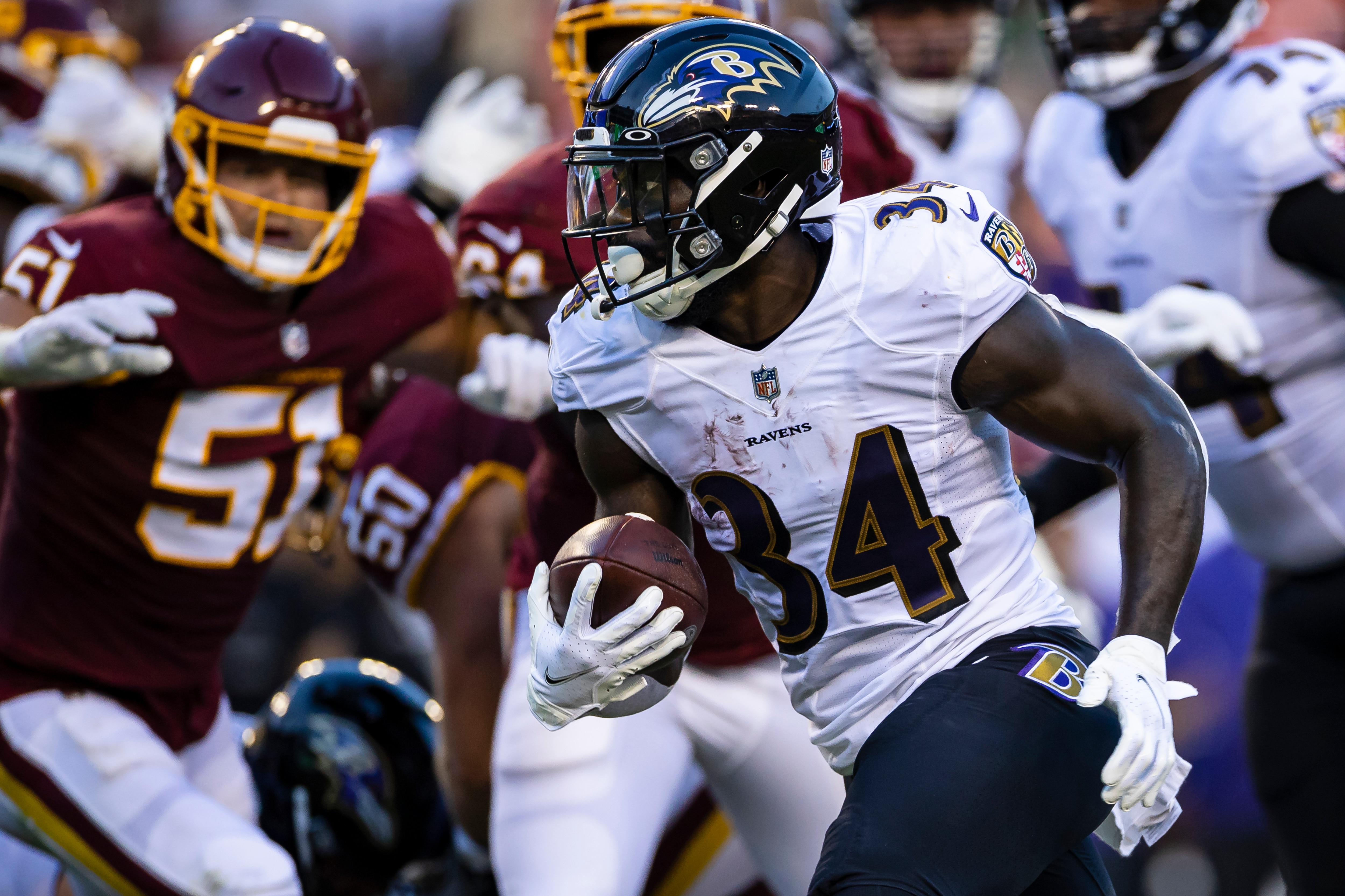 LANDOVER, MD - AUGUST 28: Ty'Son Williams #34 of the Baltimore Ravens carries the ball against the Washington Football Team during the first half of the preseason game at FedExField on August 28, 2021 in Landover, Maryland. (Photo by Scott Taetsch/Getty Images)