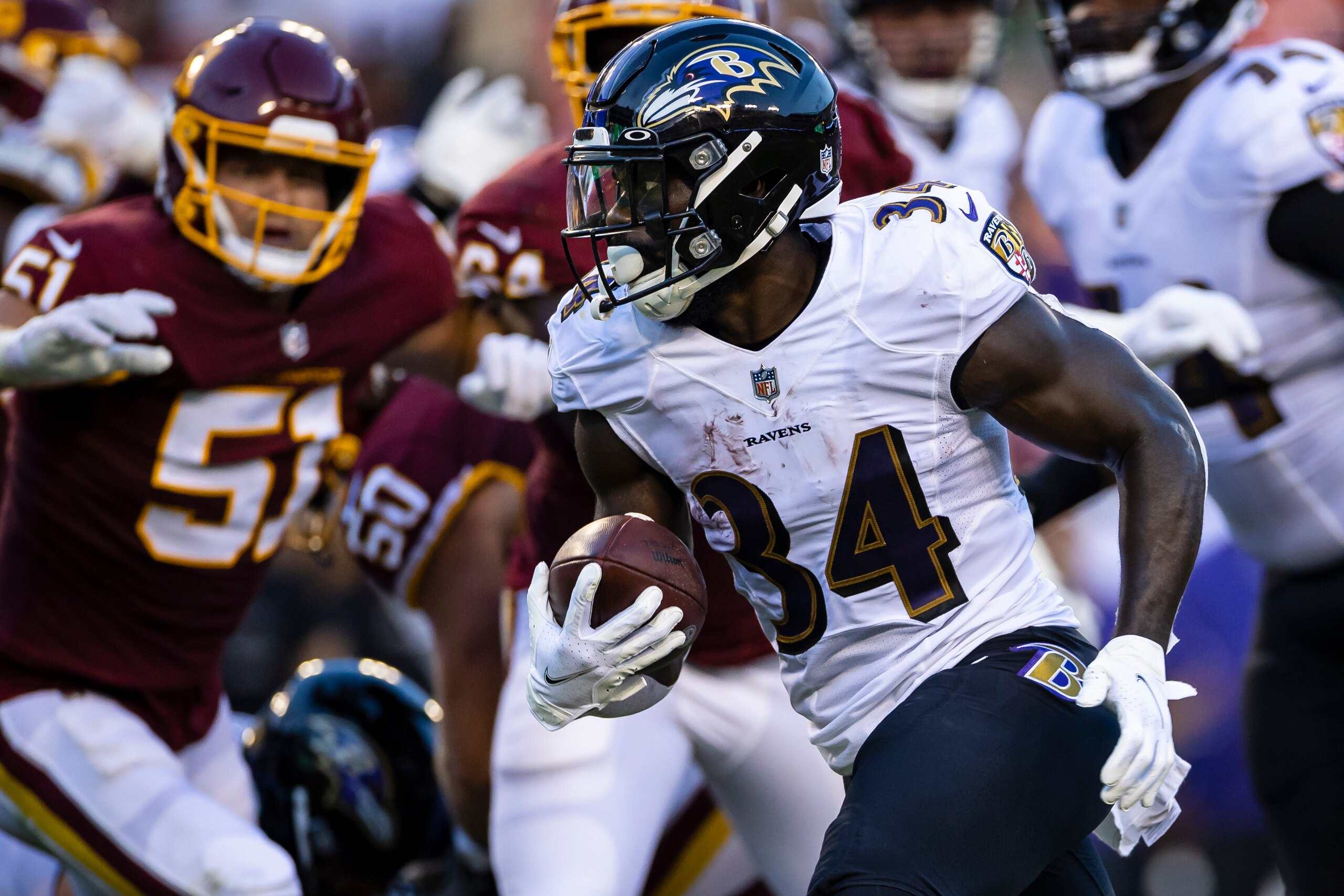 LANDOVER, MD - AUGUST 28: Ty'Son Williams #34 of the Baltimore Ravens carries the ball against the Washington Football Team during the first half of the preseason game at FedExField on August 28, 2021 in Landover, Maryland. (Photo by Scott Taetsch/Getty Images)