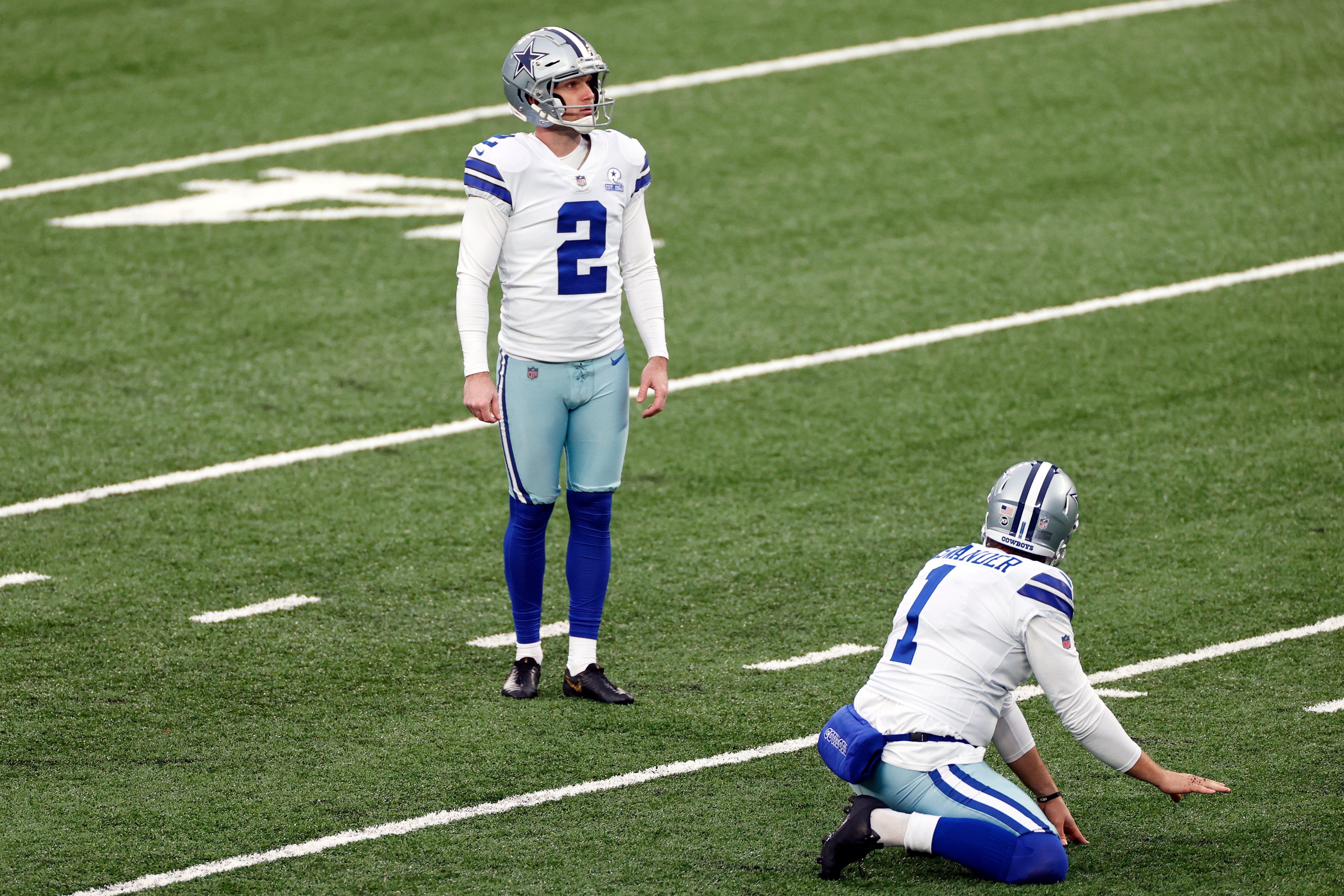 Dallas Cowboys kicker Greg Zuerlein (2) kicks a field goal as punter Hunter Niswander (1) holds during an NFL football game against the New York Giants, Sunday, Jan. 3, 2021, in East Rutherford, N.J. (AP Photo/Adam Hunger) Dallas Cowboys kicker Greg Zuerlein (2) kicks a field goal as punter Hunter Niswander (1) holds during an NFL football game against the New York Giants, Sunday, Jan. 3, 2021, in East Rutherford, N.J. (AP Photo/Adam Hunger)