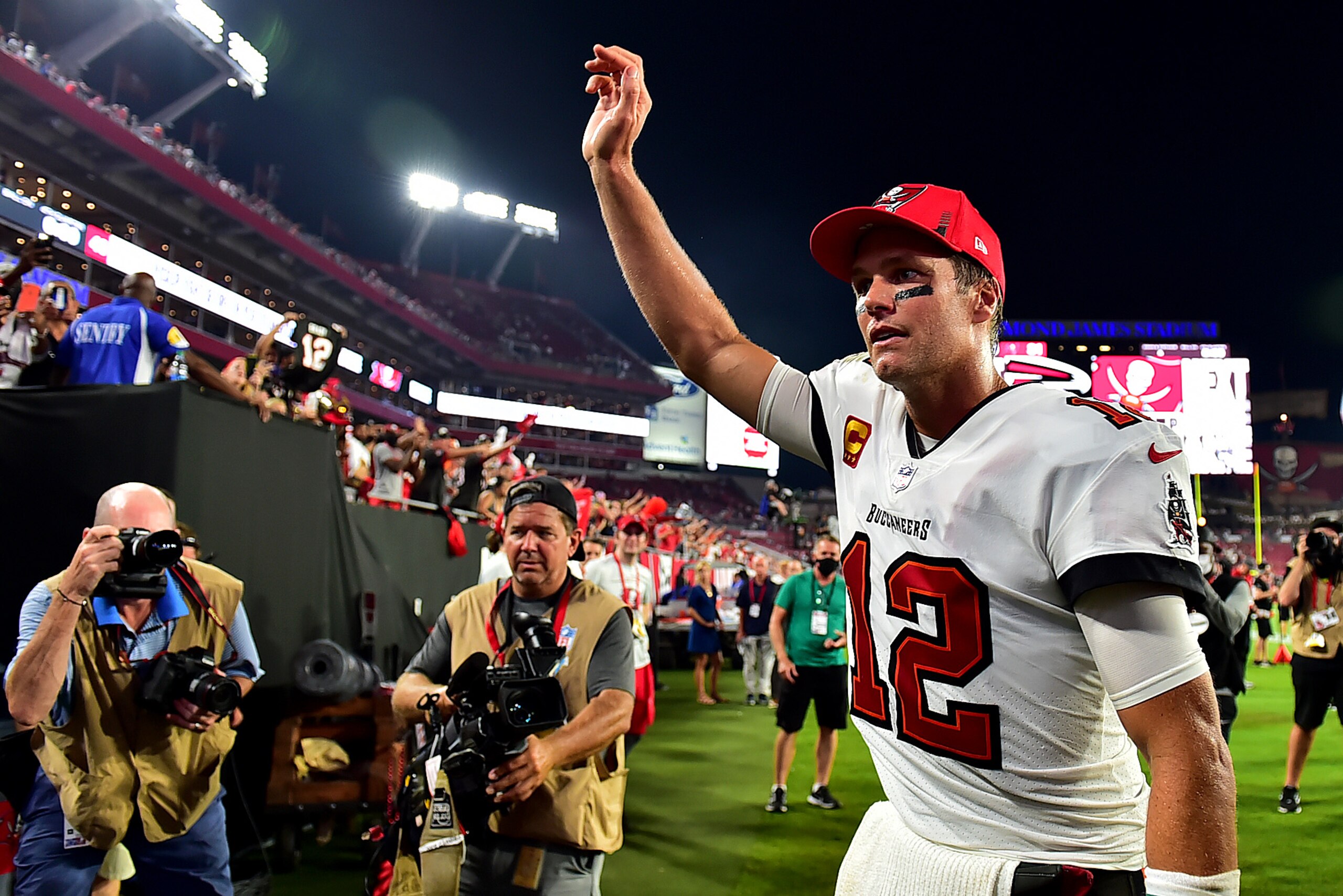 TAMPA, FLORIDA - SEPTEMBER 09: Tom Brady #12 of the Tampa Bay Buccaneers waves to fans after defeating the Dallas Cowboys 31-29 at Raymond James Stadium on September 09, 2021 in Tampa, Florida. (Photo by Julio Aguilar/Getty Images)
