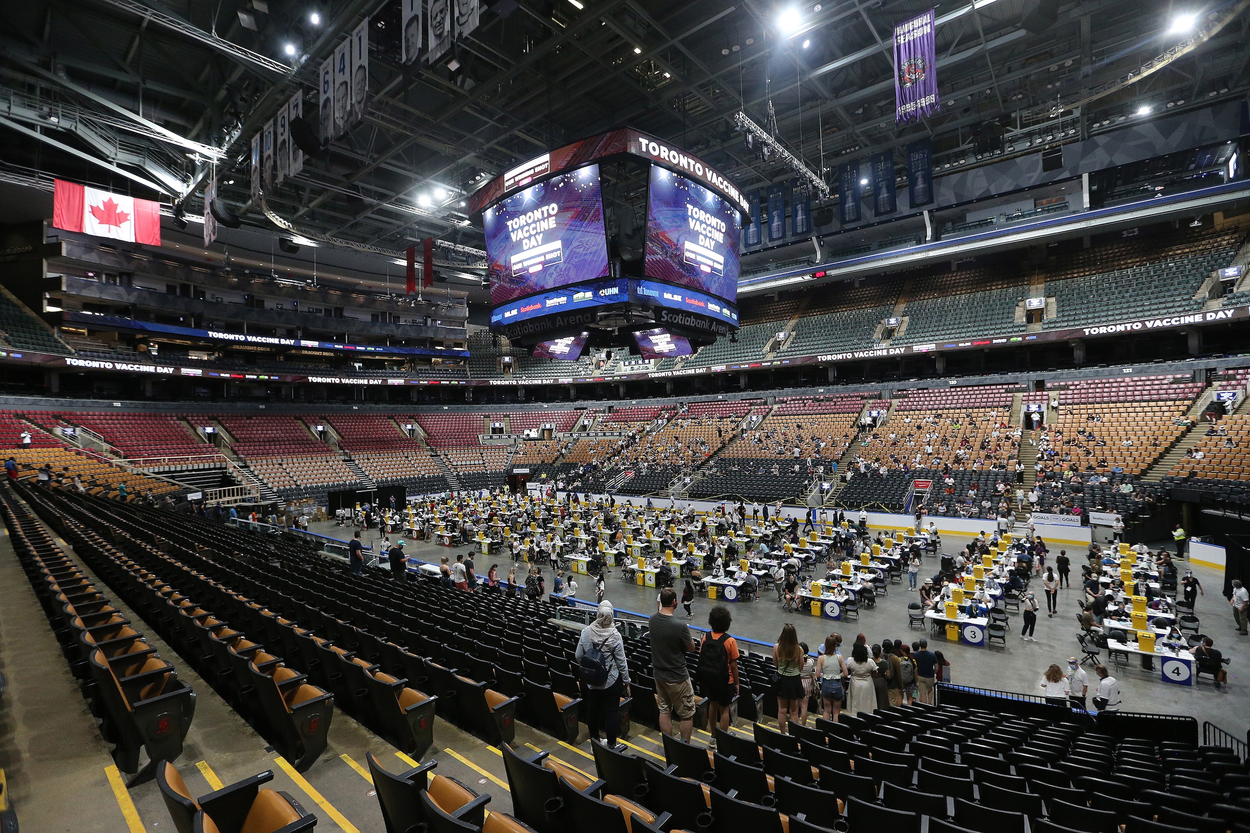 Toronto, ON- June 27  - The floor of Scotiabank Arena where the Leafs and Raptors play is filled with people getting their vaccinations. Thousands line up and are vaccinated at the Scotiabank Arena as Toronto hopes to vaccinate 25,000 for COVID-19. Ontario enters Step One of a three step reopening plan as COVID-19 vaccinations rise and new cases continue to fall. in Toronto. June 27, 2021.        (Steve Russell/Toronto Star via Getty Images)