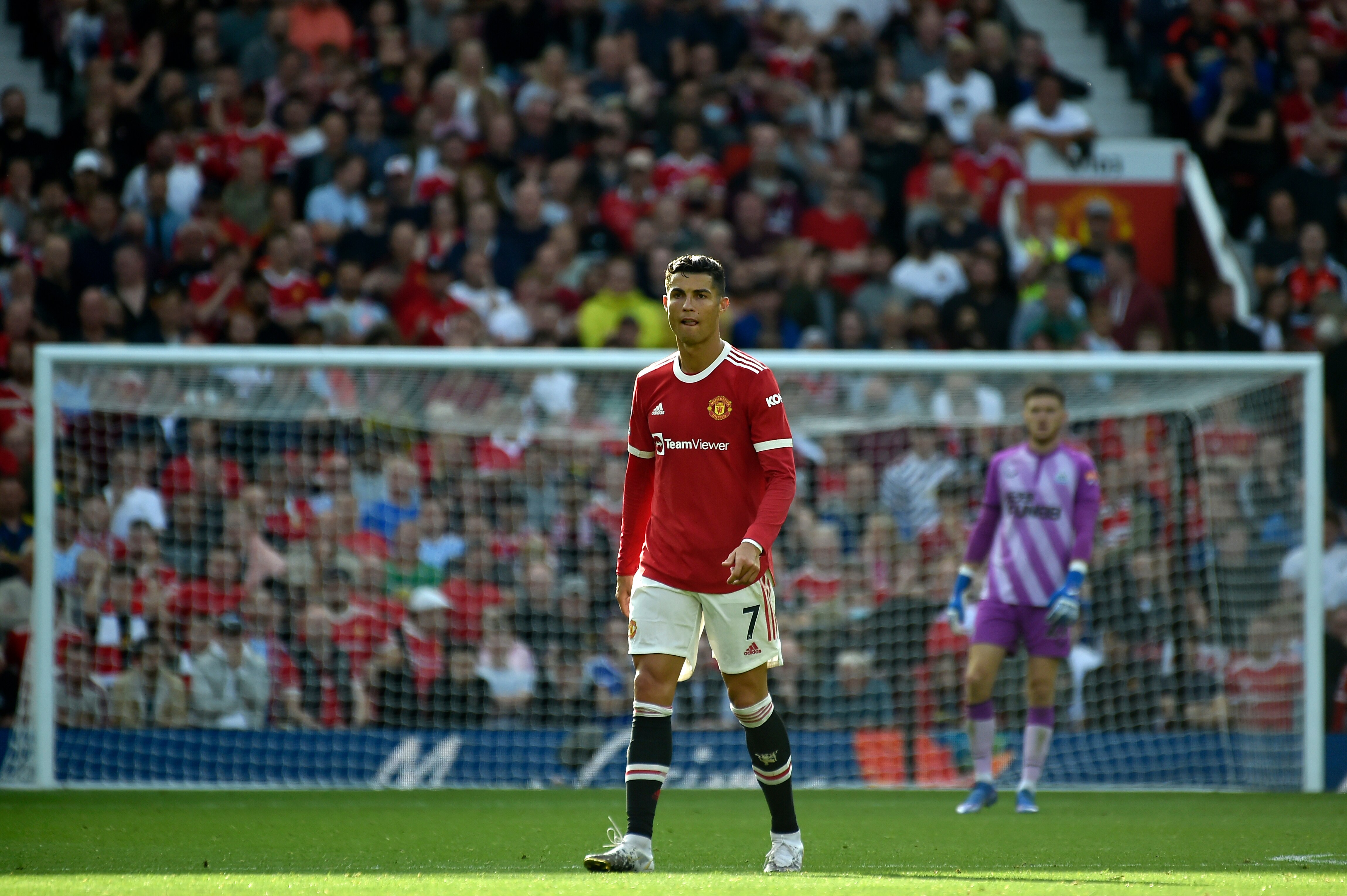 Manchester United's Cristiano Ronaldo walks on the pitch during the English Premier League soccer match between Manchester United and Newcastle United at Old Trafford stadium in Manchester, England, Saturday, Sept. 11, 2021. (AP Photo/Rui Vieira)