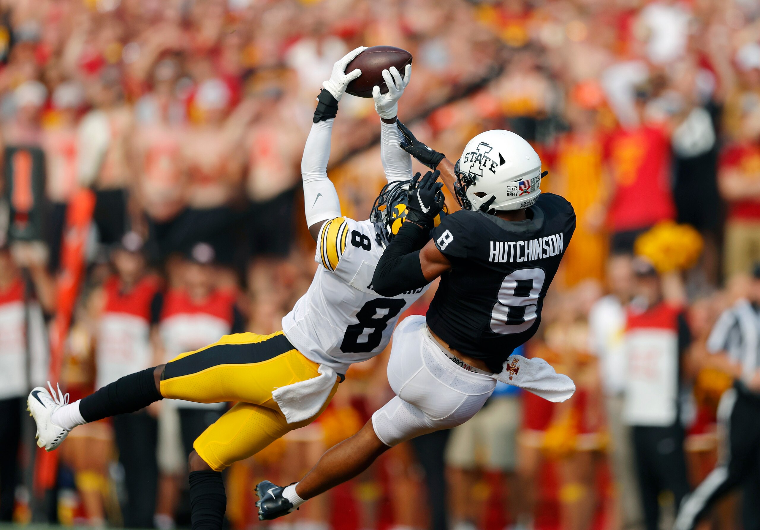 Iowa defensive back Matt Hankins (8) makes an interception in front of Iowa State wide receiver Xavier Hutchinson (8) during the first half of an NCAA college football game, Saturday, Sept. 11, 2021, in Ames, Iowa. (AP Photo/Matthew Putney)