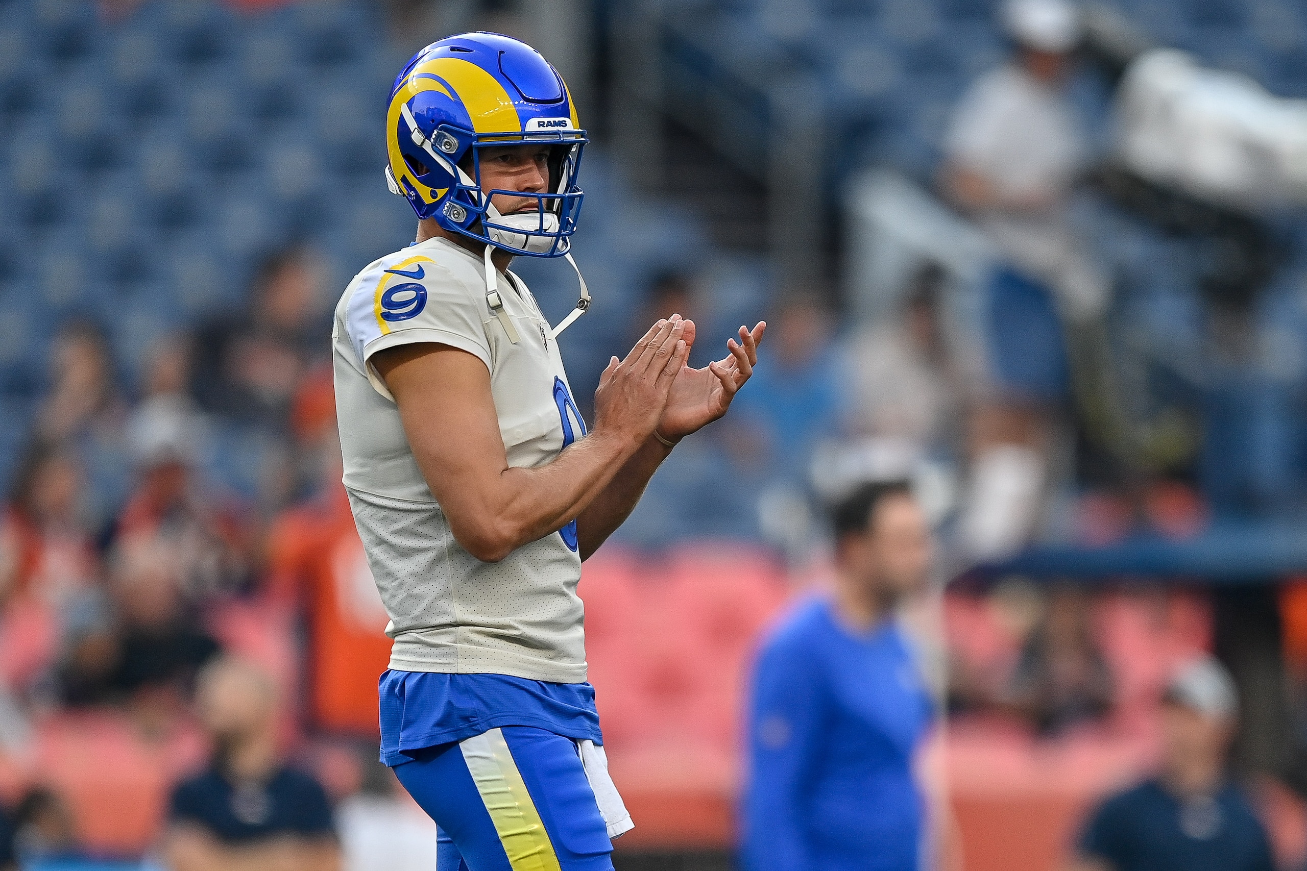 DENVER, CO - AUGUST 28:  Matthew Stafford #9 of the Los Angeles Ramslooks on as players warm up before an NFL preseason game against the Denver Broncos at Empower Field at Mile High on August 28, 2021 in Denver, Colorado. (Photo by Dustin Bradford/Getty Images)