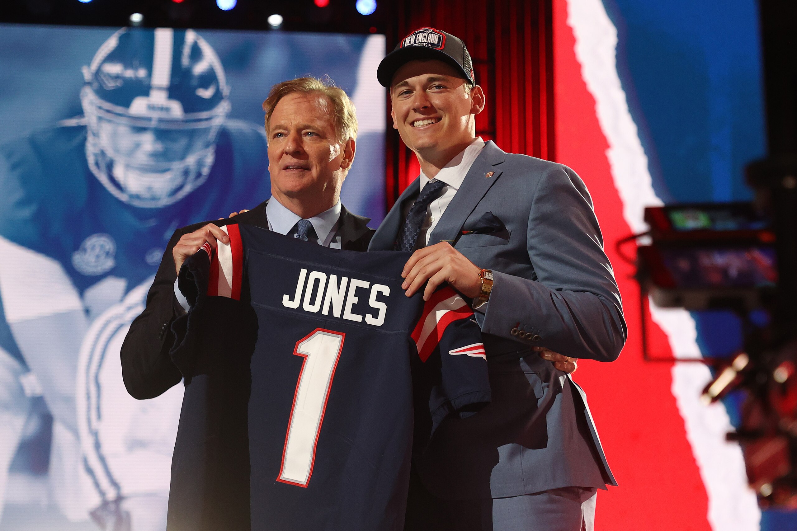 CLEVELAND, OHIO - APRIL 29: Mac Jones poses with NFL Commissioner Roger Goodell onstage after being selected 15th by the New England Patriots during round one of the 2021 NFL Draft at the Great Lakes Science Center on April 29, 2021 in Cleveland, Ohio. (Photo by Gregory Shamus/Getty Images)
