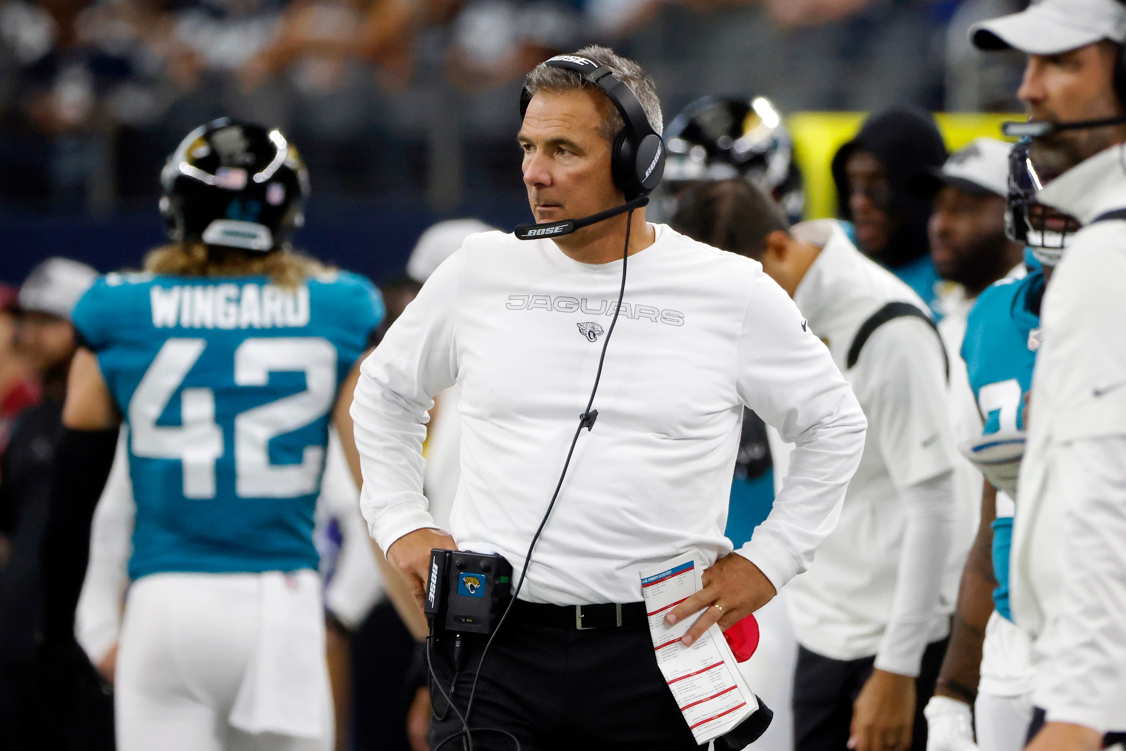 FILE - In this Sunday, Aug. 29, 2021, file photo ,Jacksonville Jaguars heads coach Urban Meyer, center, watches play in the first half of a preseason NFL football game against the Dallas Cowboys in Arlington, Texas. Meyer, unbeaten in season openers, will try to extend his 17-0 record when the Jaguars travel to Houston for their season opener.  (AP Photo/Michael Ainsworth, File)