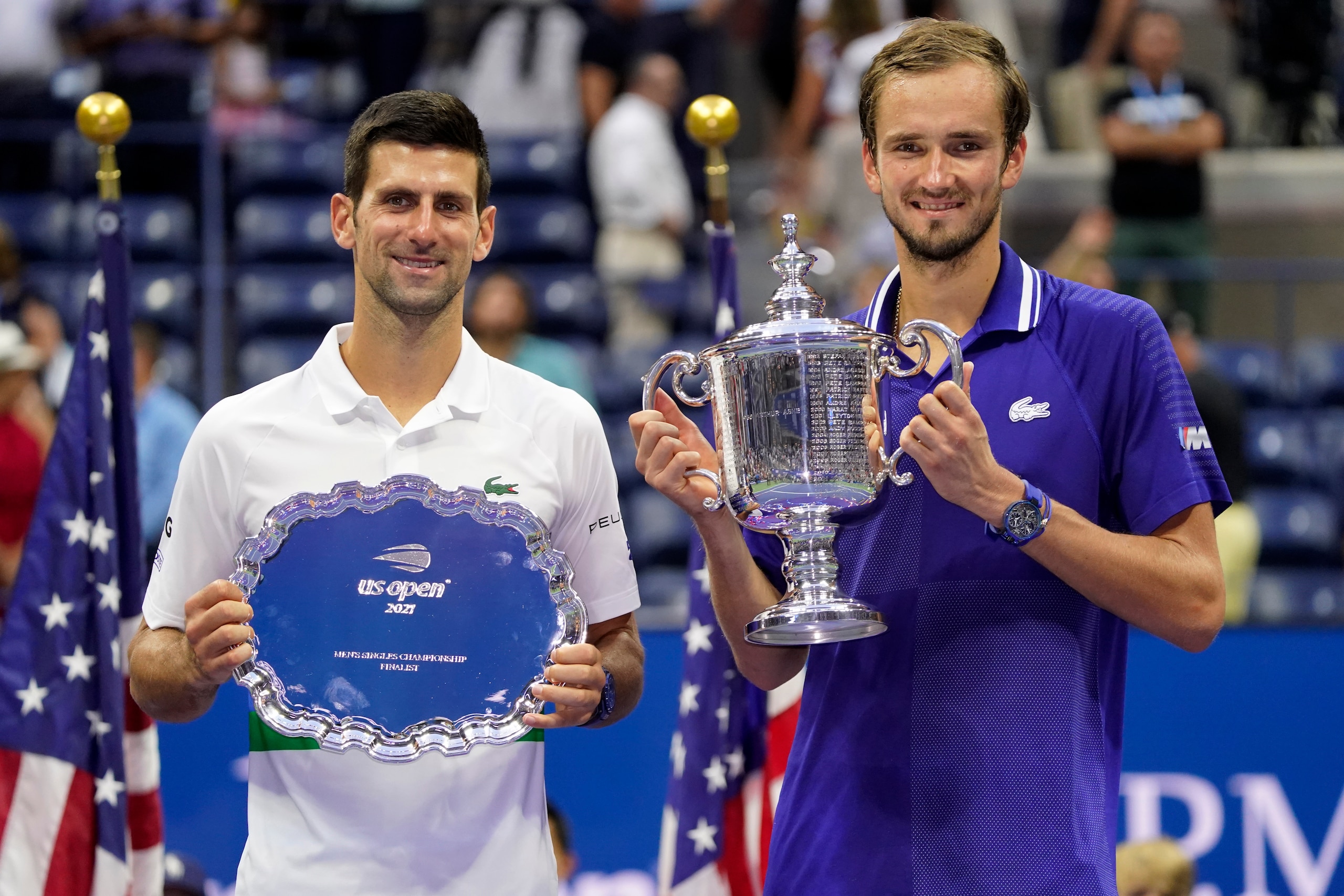 Daniil Medvedev, of Russia, right, and Novak Djokovic, of Serbia, pose for photos after Medvedev defeated Djokovic in the men's singles final of the US Open tennis championships, Sunday, Sept. 12, 2021, in New York. (AP Photo/John Minchillo)