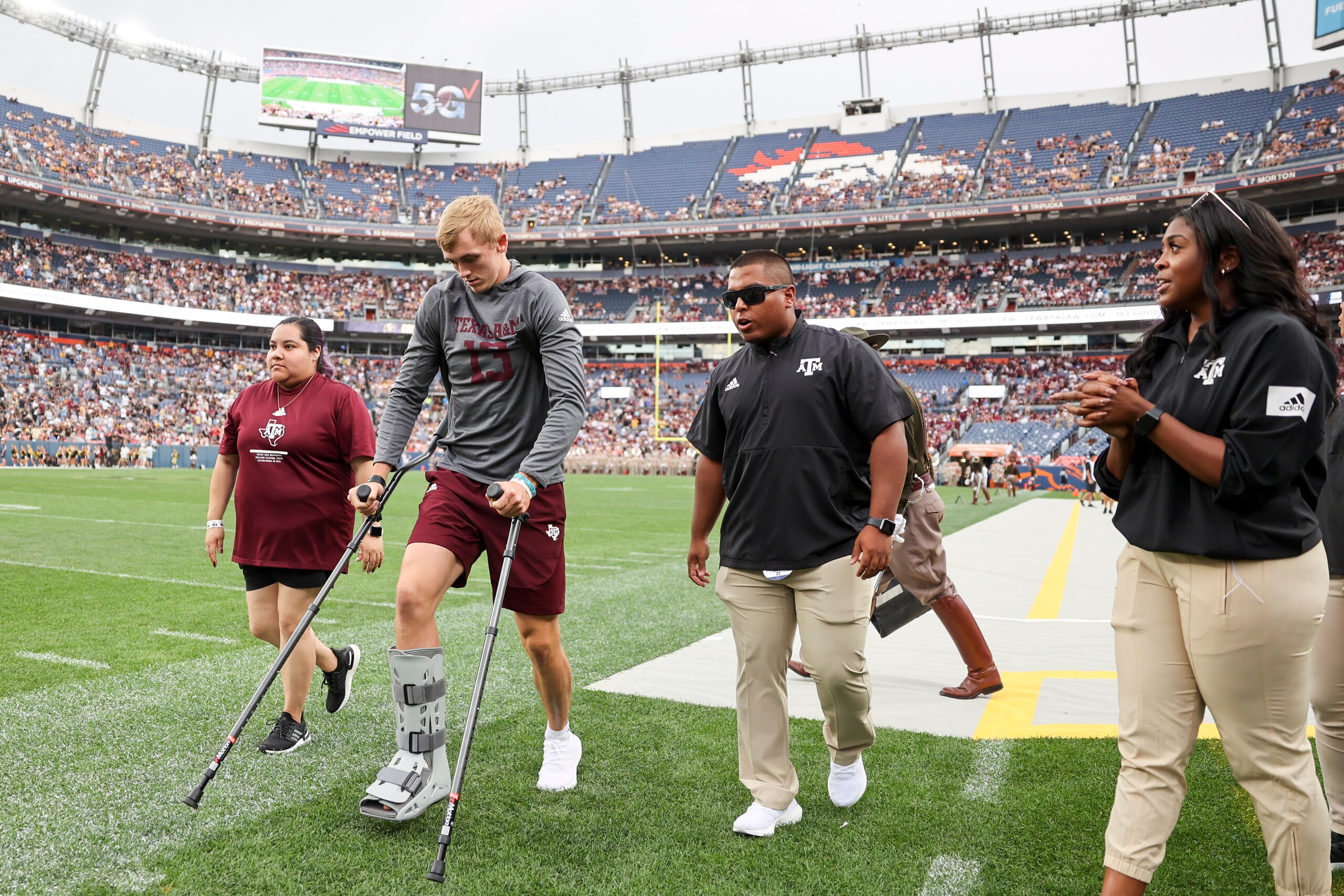 DENVER, CO - SEPTEMBER 11: Haynes King #13 of the Texas A&M Aggies walks off the field on crutches after the second quarter after he was injured in the first quarter against the Colorado Buffaloes at Empower Field At Mile High on September 11, 2021 in Denver, Colorado. (Photo by Michael Ciaglo/Getty Images)