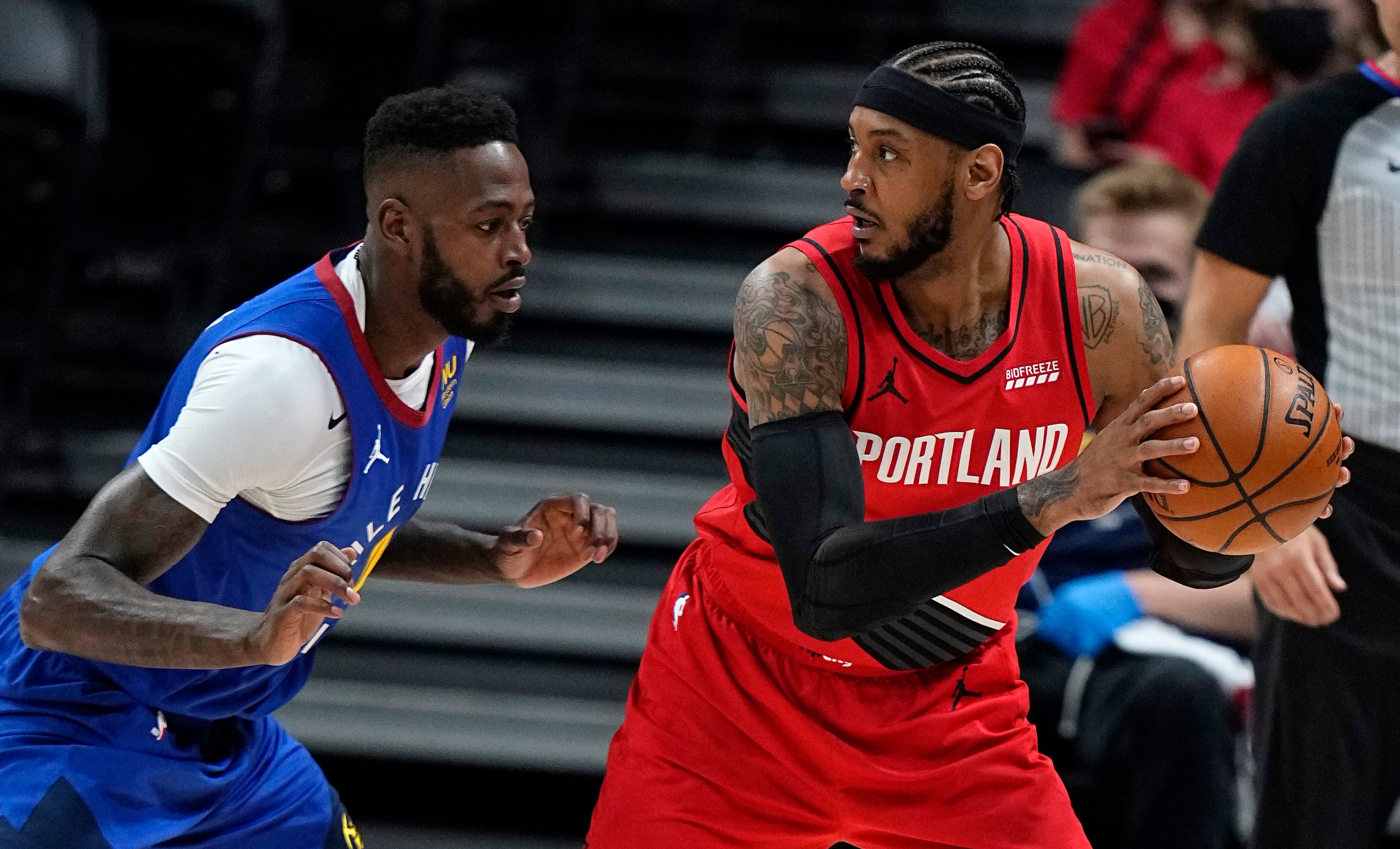 Portland Trail Blazers forward Carmelo Anthony keeps the ball from Denver Nuggets forward JaMychal Green during the first half of Game 5 of a first-round NBA basketball playoff series Tuesday, June 1, 2021, in Denver. (AP Photo/Jack Dempsey)