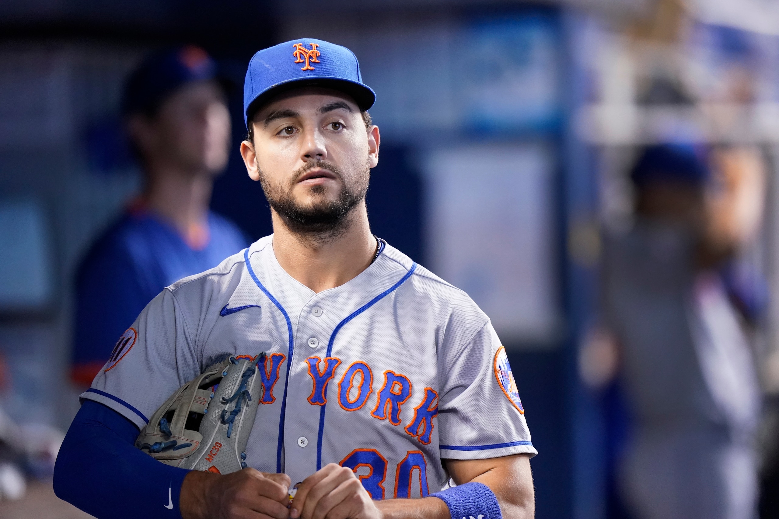 New York Mets right fielder Michael Conforto looks out of the dugout before the start of a baseball game against the Miami Marlins, Thursday, Sept. 9, 2021, in Miami. (AP Photo/Wilfredo Lee)